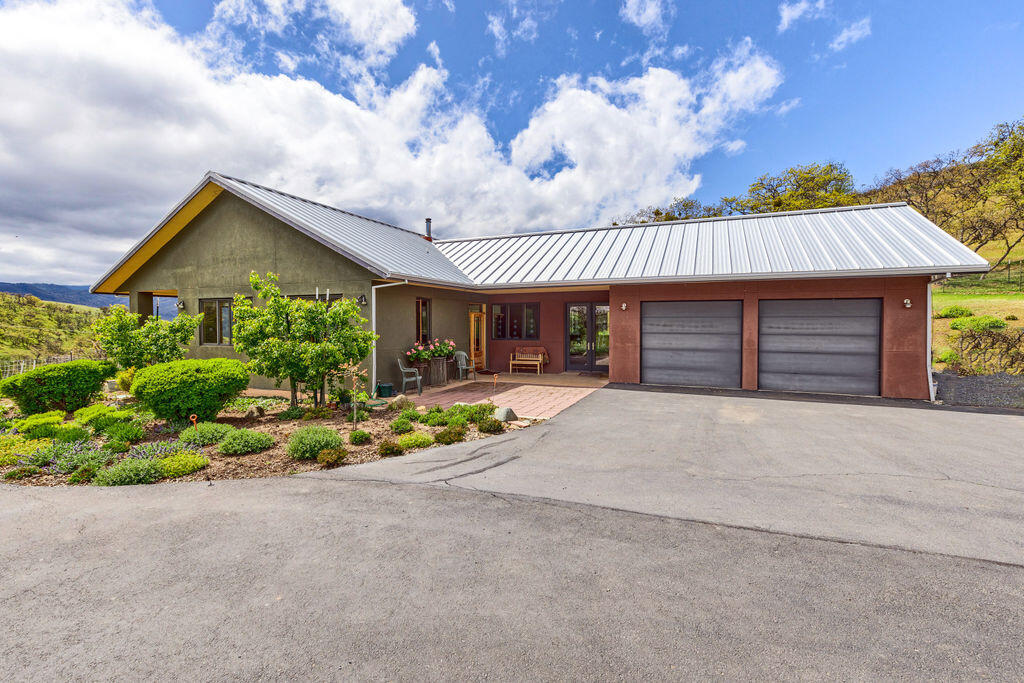 This one of a kind PEACEFUL RETREAT on 32.52 acres is a wildlife and bird lover's delight. The spacious, south facing, single level home has gorgeous views from just about every window of the vibrant open oak woodlands, grasslands, mountains and valley.  It was designed by an award winning architect for himself and shows quality in every way.  There is a 100 year metal roof, hardwood floors throughout, wood framed windows, a large, spacious office with separate entrance, covered front patio, two car garage, and RV parking. Ready for a variety of animals: cattle, horses or what the current owner has raised - miniature donkeys!  Solid barn, fenced and cross fenced, 22 acres with irrigation rights.  Horse riding trails nearby.  So quiet and private, surrounded by large parcels.  Sit in your living room and watch the  unexpected wildlife appear.  A nature lover's dream, and only about 5 miles to Ashland.