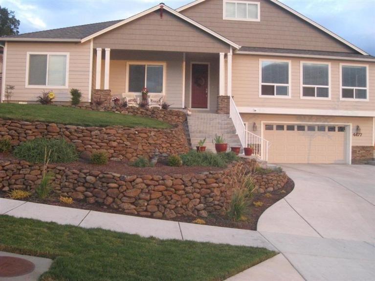 Beautiful custom home located in the East hills of Medford. Open floor plan with gorgeous wood burning rock fireplace, hardwood floors in kitchen, granite countertops, island work station, stainless steel appliances with extended warranty, large walk in pantry. Formal and informal dining room. Master suite boasts coffered ceilings with abundance of storage in master bath. Private access to covered patio. Wider hallways and doorways make for easy living. Amazing custom landscaped yard with covered patio for outdoor entertaining or gatherings year around. Oversize 2 car garage for extra storage. Time to sit and enjoy the valley and mountain views from this spectacular home. One year home warranty with First American Title supplied by the Seller.