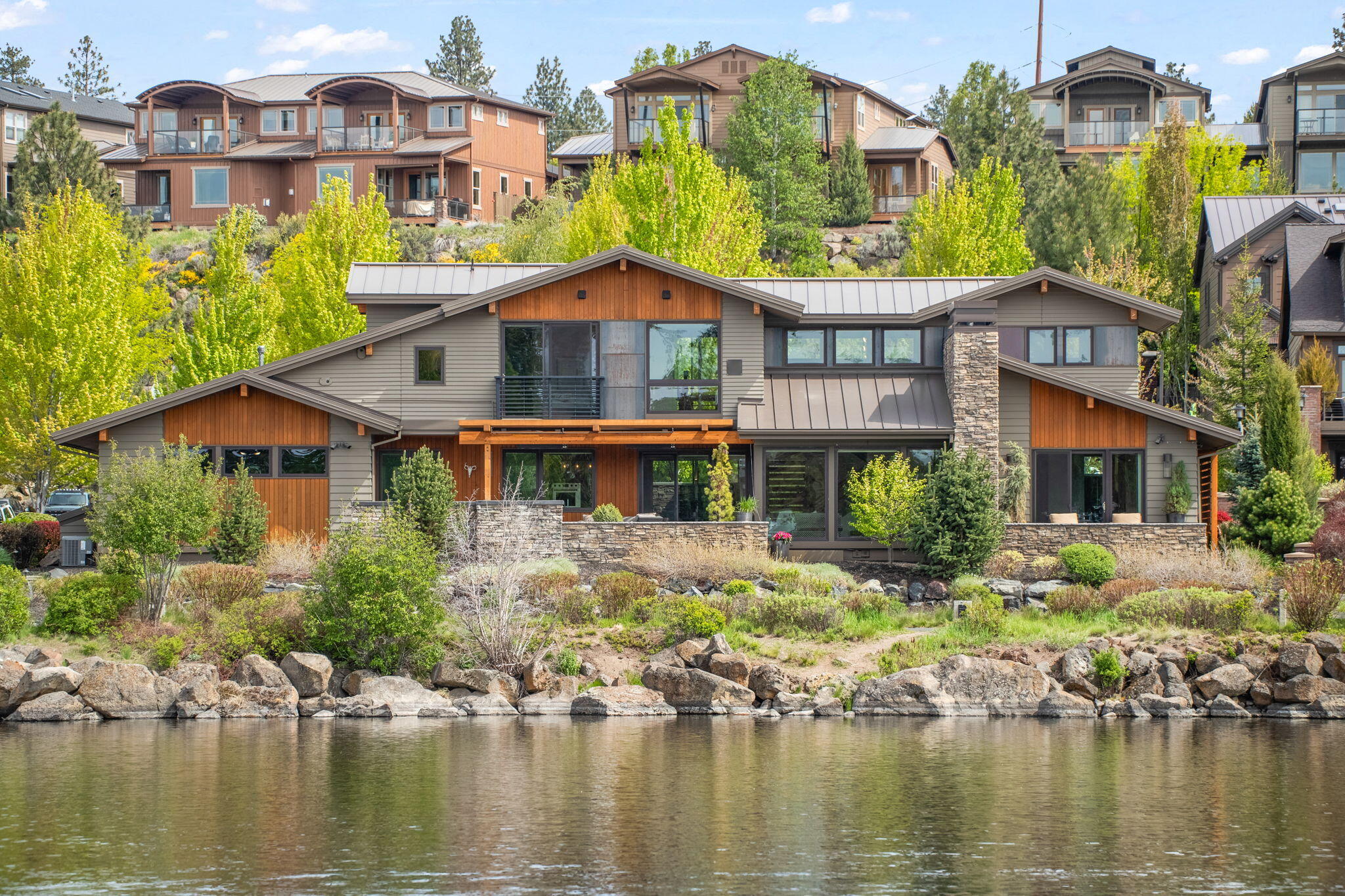 Elegance Meets Nature on the Deschutes. 849 SW Theater is a rare blend of contemporary elegance & natural harmony, offering the perfect place to put down roots without ever losing sight of the sky. Located in the premier Mill View neighborhood, this exquisite residence is perched above the Deschutes River just minutes from the vibrant Old Mill District. From the moment you step inside, breathtaking river & Cascade mtn views command your attention. Thoughtfully designed for effortless living & travel, the home features a main-level primary suite w/ a luxurious bath, large soaking tub, enviable walk-in closet, & private patio overlooking the river. The gourmet kitchen, open dining & living areas all embrace panoramic river views. Upstairs, an inspiring office captures full vistas of Mt. Bachelor & the Deschutes, while two guest suites provide elevated perspectives of the flowing water below. This captivating riverfront home puts Bend's best experiences right outside your door.