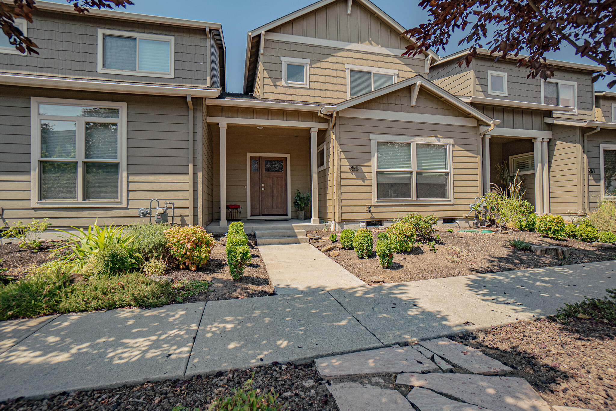 Style, Space & Spectacular Ashland Views! This Meadowbrook Park townhome features main-level living with open-concept design, abundant natural light, and stunning views. Enjoy high-end finishes throughout—corner fireplace, engineered wood floors, stainless steel appliances, granite countertops, and a private covered balcony. The spacious main-level primary suite has a beautifully tiled bath, walk-in shower, and double vanities. The guest level offers two bedrooms, a full bath, extra storage space and more amazing views. A large double garage includes extra storage and workshop space. Elevator-ready for lifelong accessibility. All in Ashland's vibrant Meadowbrook Park at North Mountain!