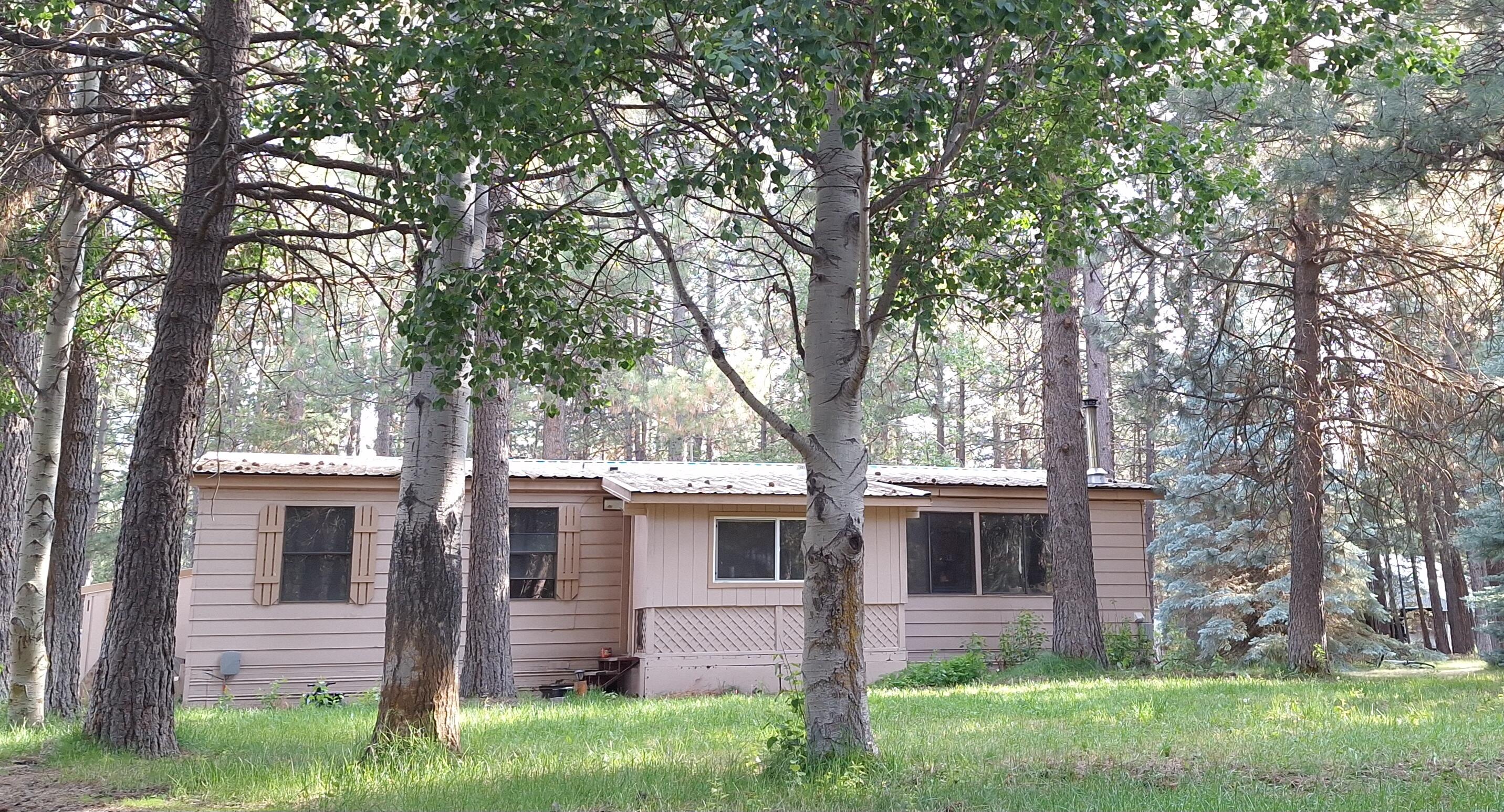 Enjoy the peaceful environment with this 2-bedroom 2-bathroom home with a large bonus room. Discover this vintage beauty, ready for your personal touch and updates. This home features updated appliances, a gas cooktop, wood stove, and an underground sprinkler system. This large lot has plenty of storage for your outdoor recreational toys, with three storage sheds and a workshop! The mature ponderosa pines make a park like setting and a small greenhouse is available to grow your own vegetables. Short distance to Deschutes National Forest Lands featuring lakes, rivers, and miles of roads to explore. There is so much potential for this home in beautiful Central Oregon!