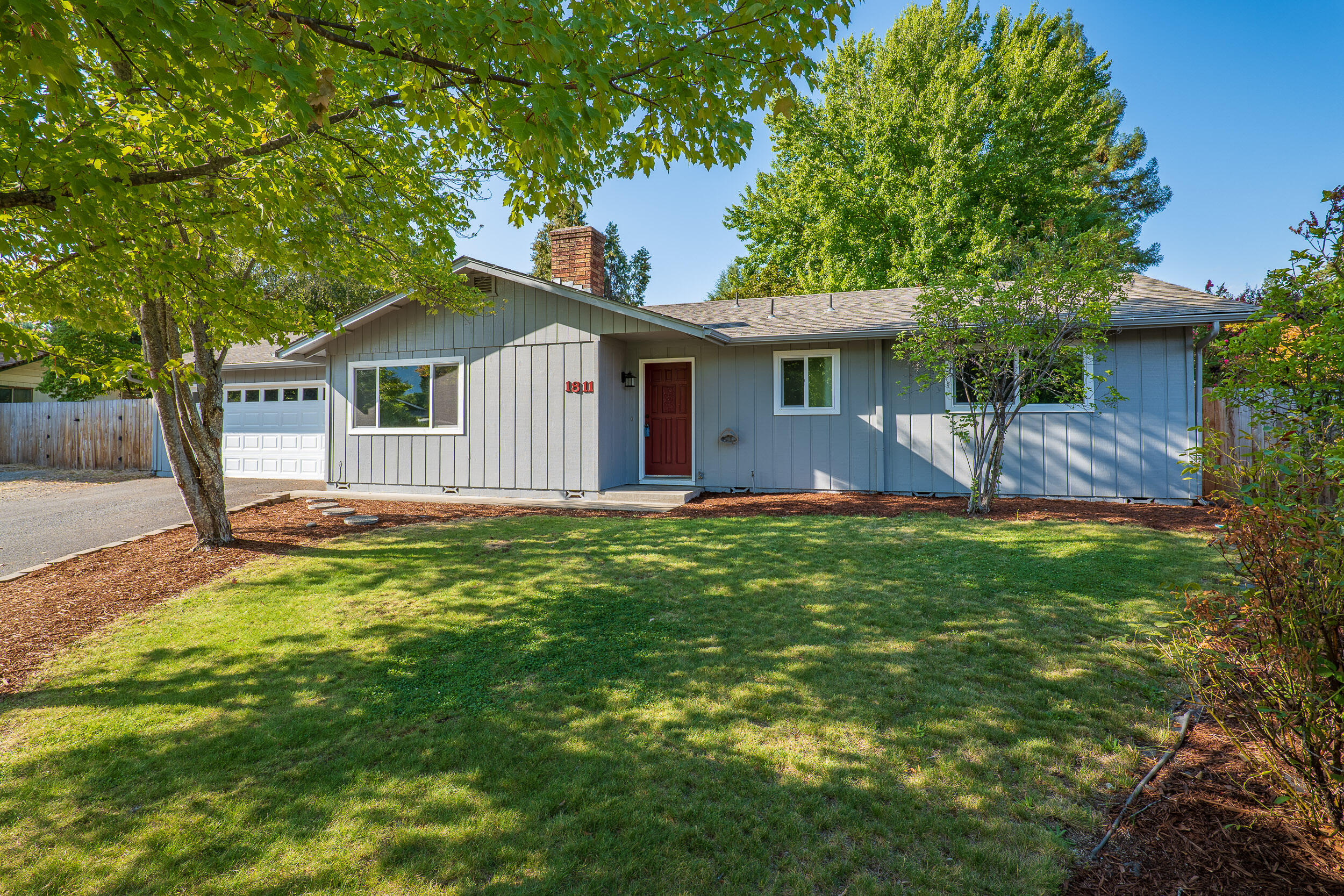 Your search is officially over!  This lovely home on a large .29 acre lot at the end of a cul-de-sac street is well maintained and move-in ready!  Relax and feel at home with this cozy 1272 square foot floorplan that features a light and bright living space complete with a functional kitchen & dining area w/ a large sliding door that leads to the covered patio and spacious tree covered yard!  The three-bedroom, two-bathroom floorplan includes a comfortable primary bedroom complete with an on-suite bath plus two additional bedrooms & a guest bath with tub/shower combo. Additional features include an energy efficient ductless heating & air system, updated flooring, windows and paint throughout, plus a new fence and an oversized two-car finished garage with work bench! You can have all this & be conveniently located just minutes to Downtown Grants Pass, medical facilities, District 7 schools, the Mighty Rogue River & more! Call today to schedule your private tour!