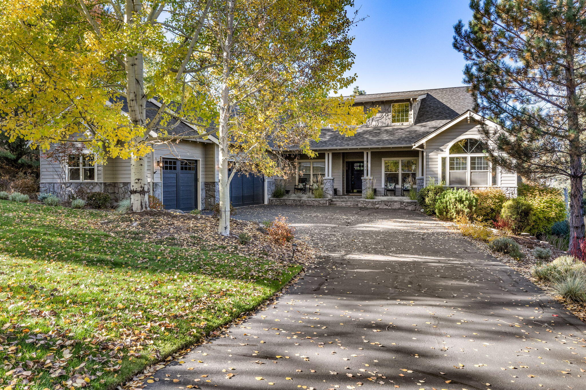 Gracious single-level home embodies timeless elegance & modern luxury. Offering versatility w/ its 3-bedroom main residence & additional 1-bed/1-bath guest quarters with private entrance. As you step inside, an impressive great room welcomes you w/ abundant natural light & a stone fireplace infusing the living area w/ sophistication & warmth. Elegant den w/ paneled wainscoting can serve as formal dining, while the heart of the home is its gourmet kitchen, w/double ovens, breakfast bar, prep sink, pantry & dining area leading to expansive deck. The primary suite is a sanctuary of refinement, w/ private deck overlooking backyard & a double-sided fireplace gracing the bedroom; extending its warmth to the bath, w/ dual sinks & soaking tub. Addtnl guest rooms & separate guest quarters, offer comfortable retreats for family & visitors. Charming front porch provides a warm welcome, while the backyard, w/ hot tub & mature landscaping, offers space for outdoor enjoyment. Spacious 3-car garage