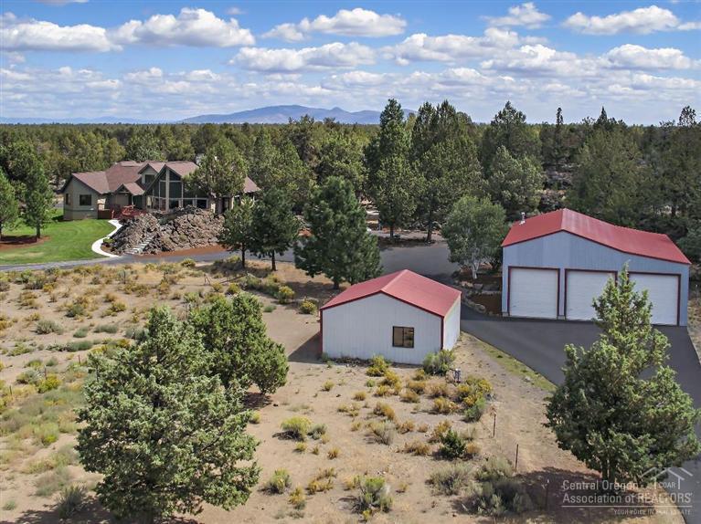 From the spectacular views of the Cascades to the freedom of exploring the bordering BLM land, this home is your own private retreat close to town. The 3,713 sf home is set back on a gorgeous gated 10 ac. parcel balanced with natural rock, mature trees and open space. A 21 ft. high elegant river rock fireplace graces the vaulted living space which flows to the wonderfully updated gourmet kitchen. Detached 2,000 sf shop with RV garage and storage plus a 2 horse stable. This is truly a special property.