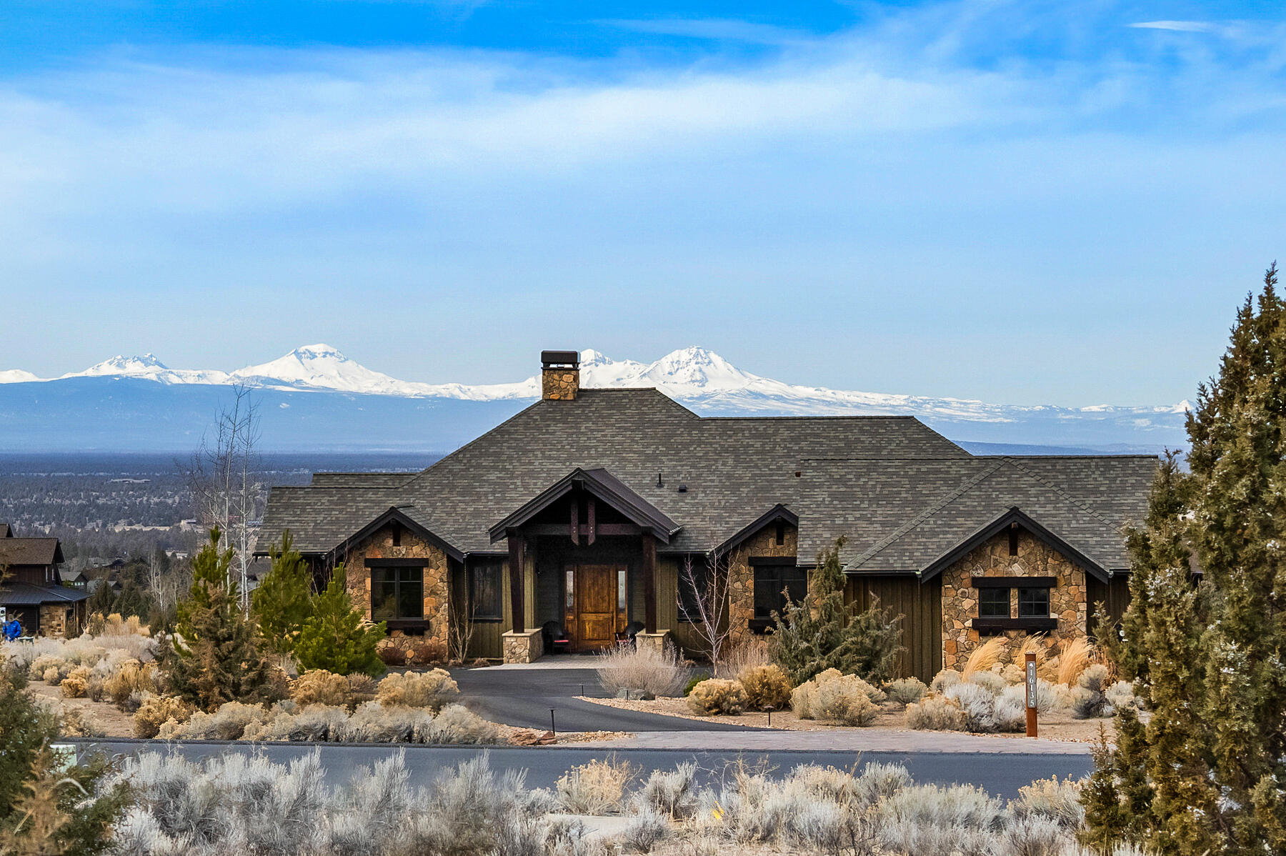 Enjoy the gorgeous views of the Cascade Mountains from the large outdoor deck, with fireplace, outdoor BBQ and refrigerator. Automatic indoor blinds and outdoor power shades. Beautiful ranch style home with extensive beam work, 12 x 12 timbers in entry, natural stone fireplace, vaulted ceilings in great room, coffered ceilings in master and dining area, hardwood floors throughout, slab granite kitchen countertops, stainless steel appliances, knotty alder cabinets, tile showers and so much more.