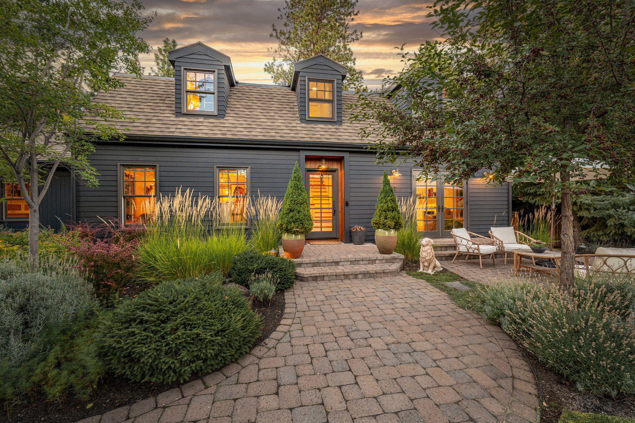 Curated for a life well-lived, this West Hills retreat offers quiet luxury and the ease of Bend living. Nestled beneath tall Ponderosa pines on multiple tax lots, including a separate buildable parcel, this estate offers rare privacy just minutes from downtown Bend. Inside, natural light pours through expansive windows, highlighting an open layout centered around a gas fireplace and gourmet kitchen. The spa-like primary suite features a soaking tub, steam shower, infrared sauna, and private patio. A versatile bonus suite above the 3-car garage adds space for guests, work, or play. The outdoors is a hallmark of this home with the pristine landscaping offering a park like setting. A treat you will have to see to appreciate fully, is the heated garden studio which is ideal for yoga, art, work or rest. There is no doubt countless hours will be spent under the stars, with the charm of a timeless farmhouse, restored to perfection, as your sanctuary at the end of the day.