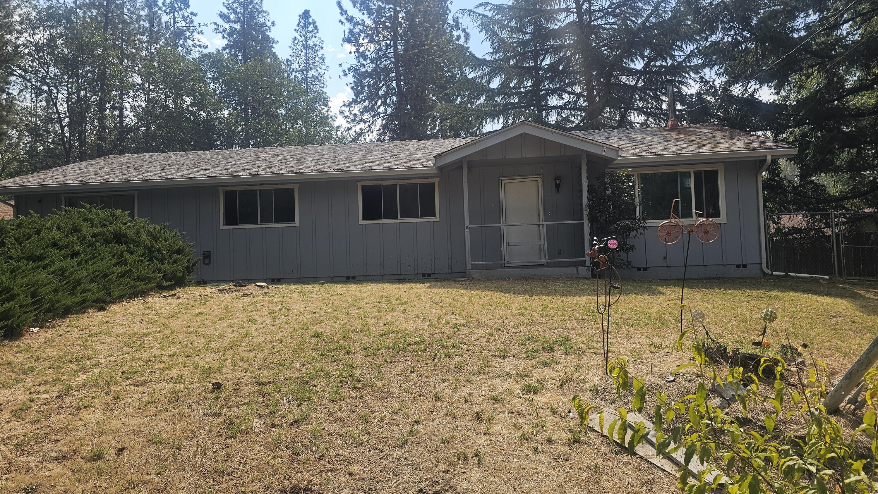 This open 1,740 sq. ft. home offers 3 bedrooms, 2 bathrooms, and a detached 2-car garage, all on a generous half-acre lot just minutes from town. The property features mature fruit trees and sweeping views overlooking the neighborhood, with a natural drainage area behind the home ensuring lasting privacy—no one can build directly behind you.

The spacious 528sq ft detached garage provides flexible options for parking, storage, or even the potential for an ADU (buyer to verify). The home itself has great bones and a spacious, single-level layout, ready for updates and personal touches. Offered as-is, this property is ideal for buyers looking for a fixer-upper with excellent potential to renovate or customize to their taste. With its desirable location, established lot, and solid design, it's a fantastic opportunity in Grants Pass.

Buyer to do their own due diligence.