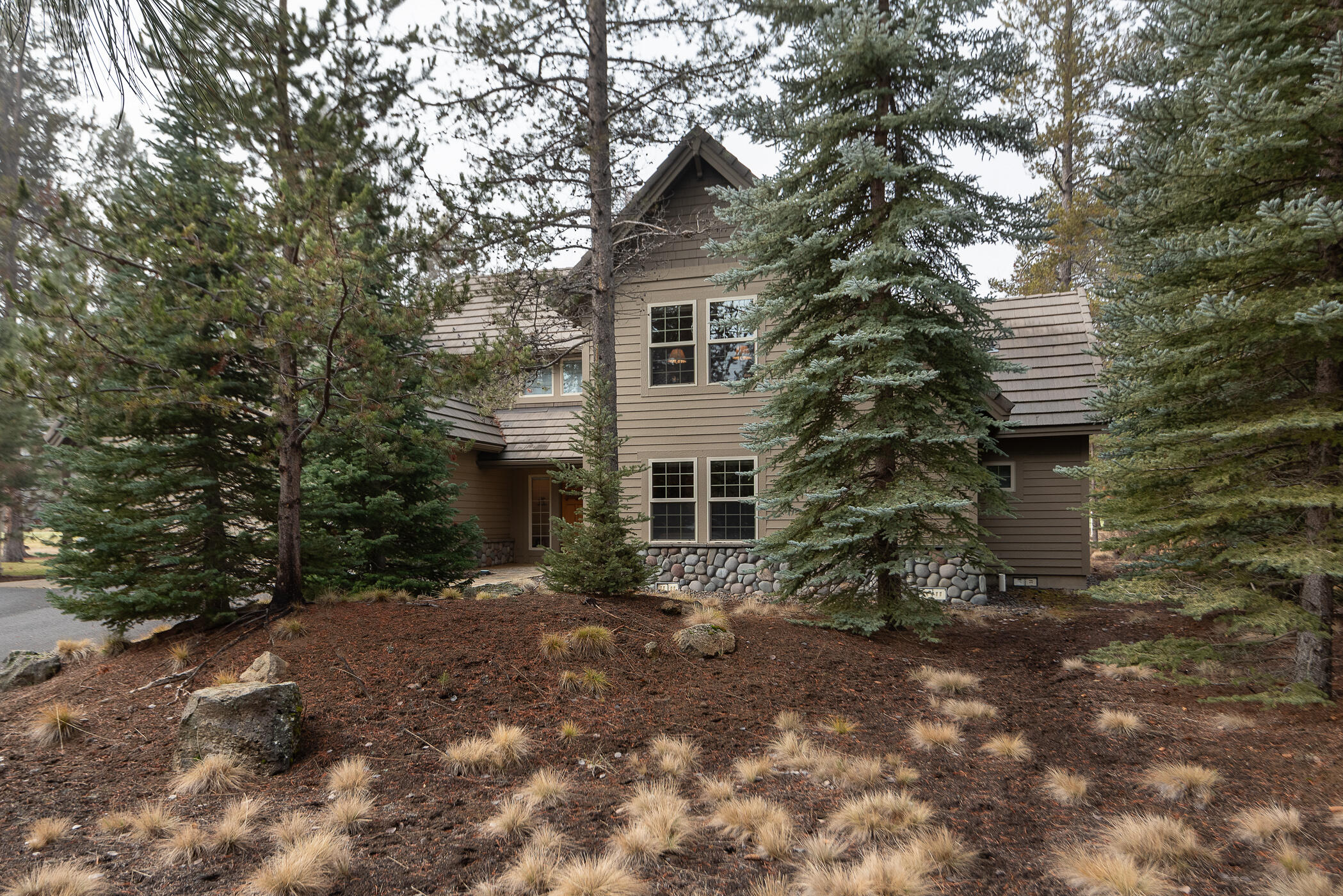 First time on the market since 1999! 
Making memories is what it is all about in this impeccably kept, classic Sunriver 2-level on sought-after Bunker Lane backing to Woodlands Golf Course. This vaulted great room plan features top-quality finishes and upgrades including a dramatic river rock, natural gas fireplace & a wall of oversized windows to a peaceful golf course and wildlife view.Updated and upscale kitchen with Bosch appliances, granite counters & breakfast bar, open to a large dining area showcasing hardwood flooring and light open common spaces.Also featured on the main level is a roomy master suite and second ensuite bedroom as well as laundry and walk-in pantry.Upstairs you'll find bedrooms #3 and #4, plus a fifth bedroom (or large bonus room) and nice open loft area as well as another full bathroom.Exterior features include cedar siding, tile roof and paver patio complete with private hot tub on a .36acre lot.  This home has been lightly used by family only, not rented