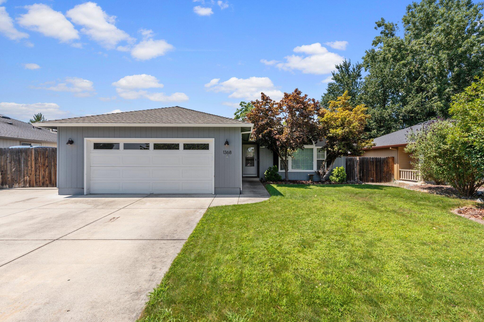 We Have the Key to Your Future!  This single story Decarlow built home offers not only an extra large gated RV parking area, but also an immaculate in ground pool. Inside this stunning South West Medford residence you will find a combination of complementary carpet, tile, beautiful simulated wood flooring, vaulted ceilings, large windows, a step-down living room, separate entry way with coat closet, a sleek kitchen with stone countertops, white cabinetry with contrasting hardware, stainless steel appliances and a connecting dining room with modern pendant lighting that leads conveniently to the back yard from the large sliding door. There is also a mudroom, 2 more sizable bedrooms with a common bath, and a primary suite with a large walk in closet and private back yard entrance. Outside their is low maintenance landscaping, additional storage shed, and 2 car garage.