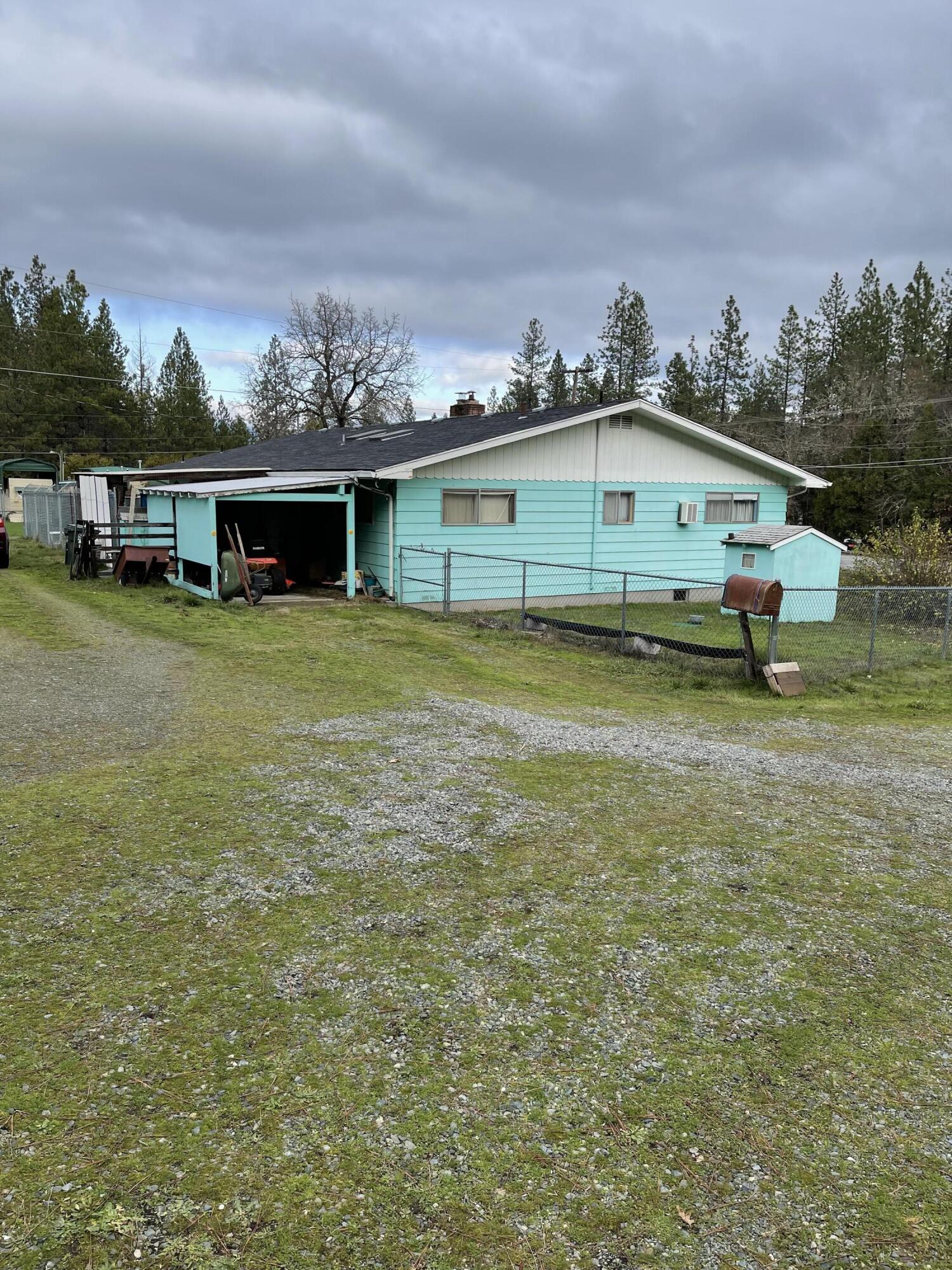 A desirable 1.25 acre lot close to town in Grants Pass! This home was built in 1965 and has 2004 sq ft. The 2 car garage was turned into a bonus room and is not included
in the square footage. The roof was replaced approximately 7 years ago. There is a 1 car garage, attached, and another 1 car garage, detached, with an RV carport
complete with utility connections. and workshop. Yard is fenced in around home to secure pets and there is another fenced area that was once used to accommodate
horses. Bring offers quickly, priced to sell and won't last long!