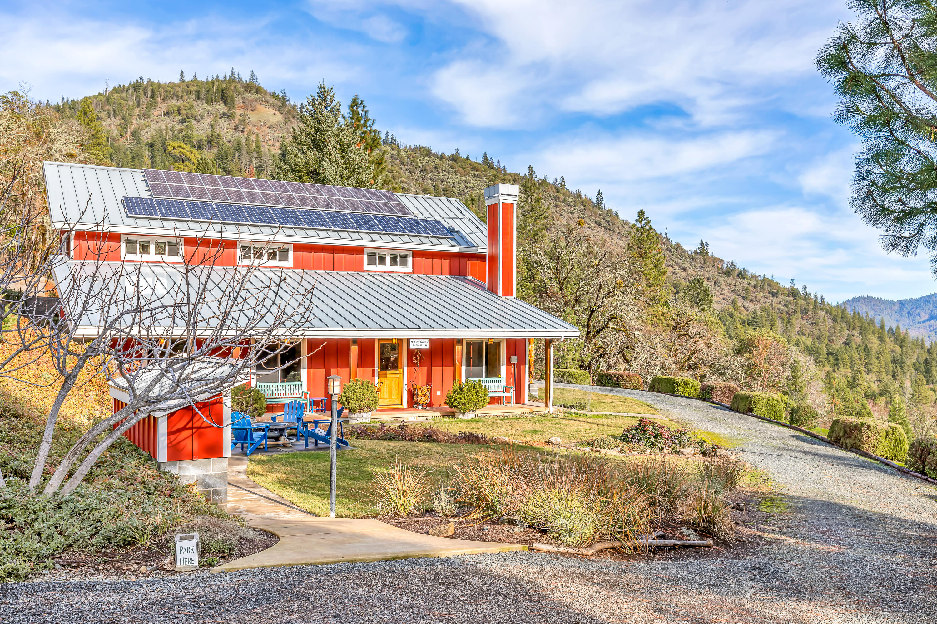 Refined custom view home with rare potential two-family setup on 95+ acres located just five miles from downtown Rogue River! Vaulted great room with reclaimed Canadian oak floors, gourmet kitchen with Silestone and oak counters, Shaws farmhouse sink, and stainless appliances including an oversized Thermador refrigerator, Electrolux convection oven, and 6-burner propane cooktop. Main-level primary bedroom with built-in Walnut headboard and expansive walk-in closet. Primary bath with granite counters, cherry cabinets, soaking tub, shower, and water closet. Elevator or interior stairs to vaulted upper level with office, spectacular artist studio with skylights, half bath, and French doors to covered decks. Guest apartment with two exterior entrances, kitchenette, bedroom, bonus room, and full bath with solid slate counter and tub shower. Contiguous parcels make up over 1,100 acres of undeveloped BLM property. Birdseye Creek is FirewiseUSA® certified since 2020. Inquire for details!