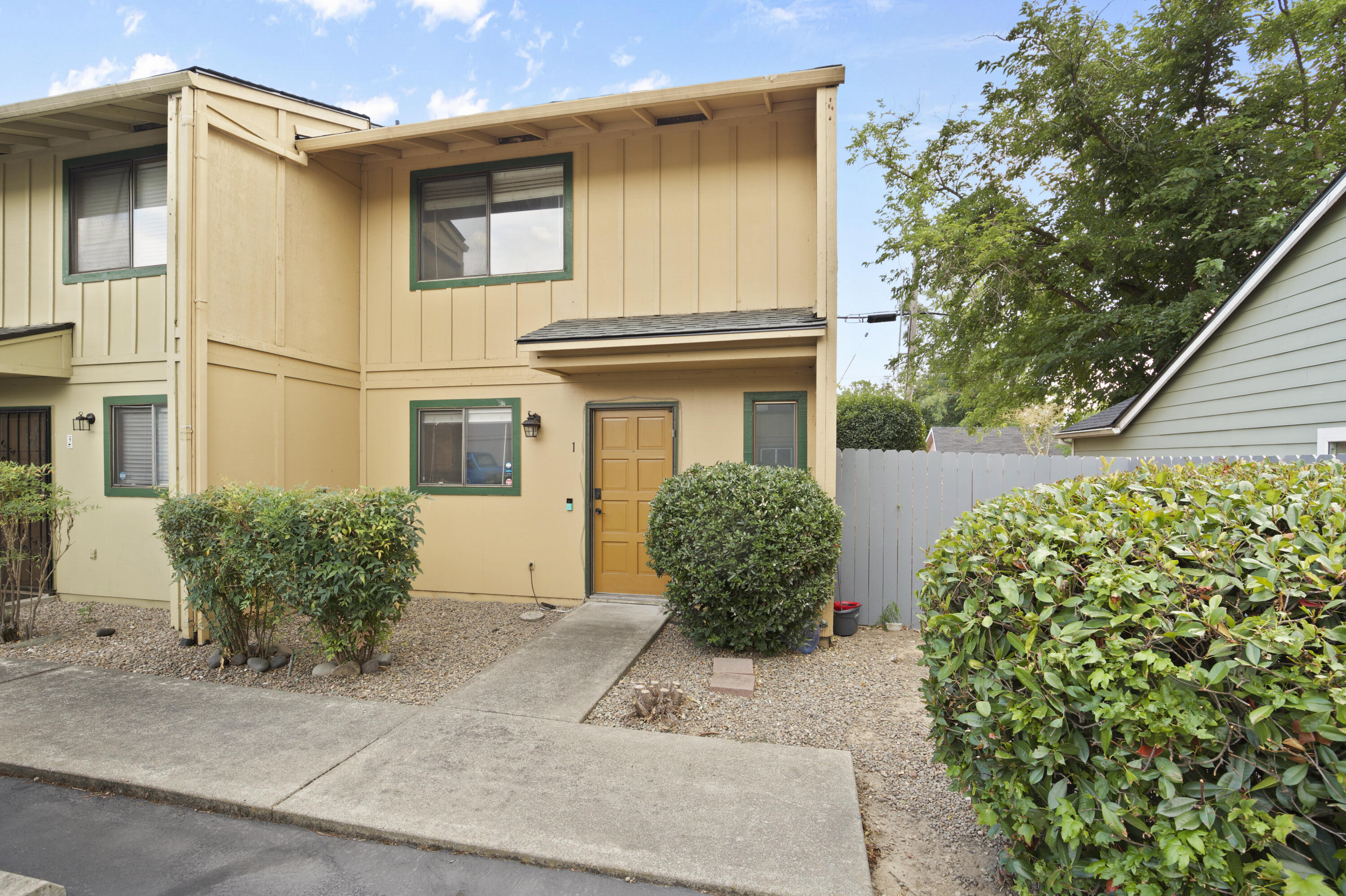 Don't miss this end unit condo with two parking spaces right out front! The kitchen flows into a spacious dining and living area, with a side window that brings in extra natural light and direct access to the patio. Laminate flooring runs throughout the main level, with carpet on the stairs for comfort. Upstairs, the primary bedroom features its own balcony and walk in closet. Main bathroom includes tile floors, a shower/tub combo, and an updated sink and counter. Recent upgrades include a newer roof, water heater, and fence! Outside, enjoy your private fenced backyard and patio!