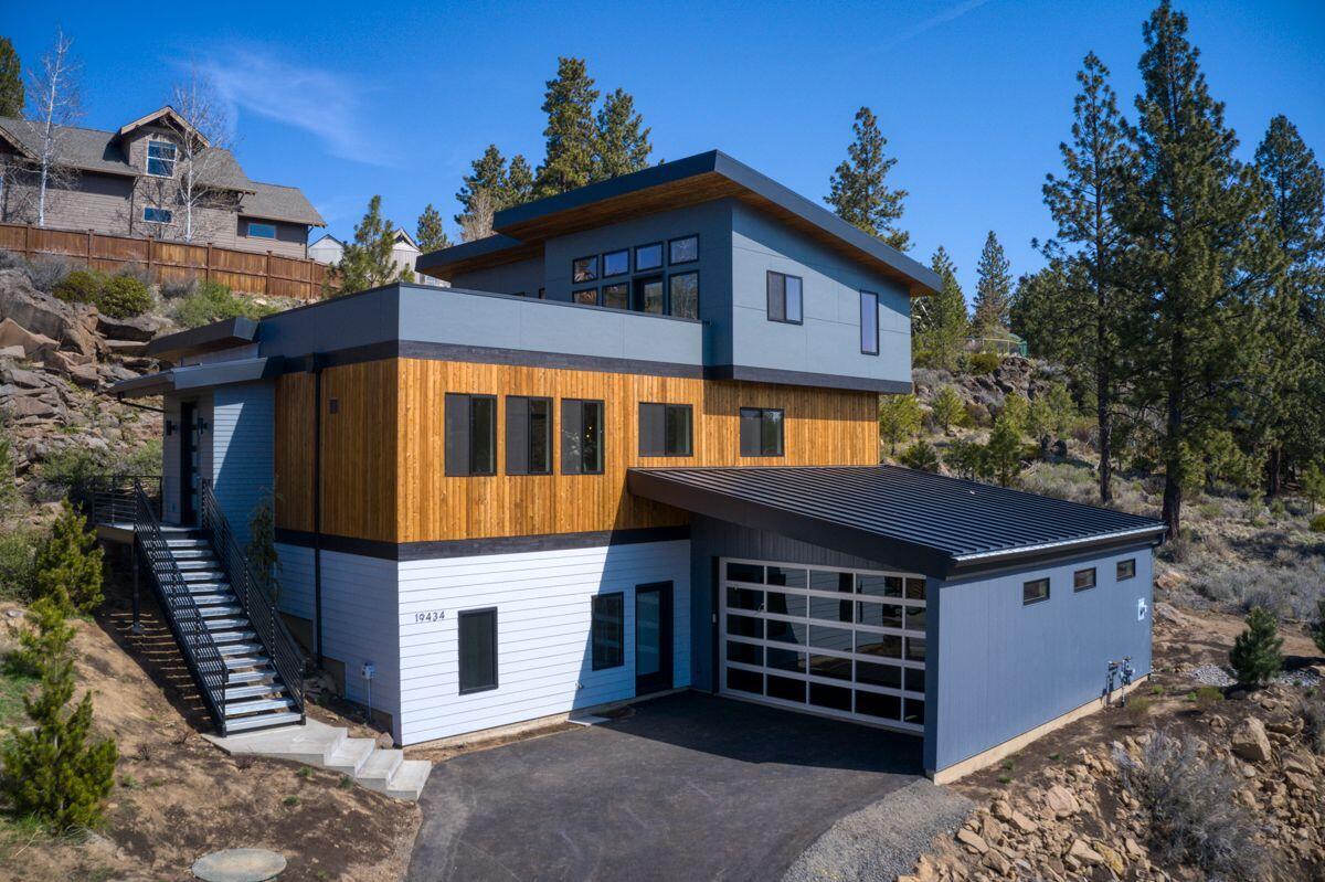 You cannot get much closer to the mountain. This house is right on the way
to Bachelor, only 20 minutes away. Paved bike trail is across the street.
Privacy and views: the house is backed up against a natural rock wall which
gives the bedrooms, great room and inner courtyard complete privacy. The
rooftop deck is pre-wired for a hot tub and provides hilltop views. The
windows have special glazing to reduce road noise. All ceilings and walls
have maximum insulation for sound and thermal energy benefits. Tesla
vehicle charger installed in garage. The house features a 100-year metal
roof and snow-guards for worry-free winters. Drip irrigation installed for
all landscaping. Kitchen features Italian Fulgor Milano appliances and
waterfall island. Lock-out lower level features two bedrooms, a
kitchenette, a stackable washer/dryer and large storage room. This level
would make a great separate office or rental. No monthly HOA, but Tetherow
membership can be purchased