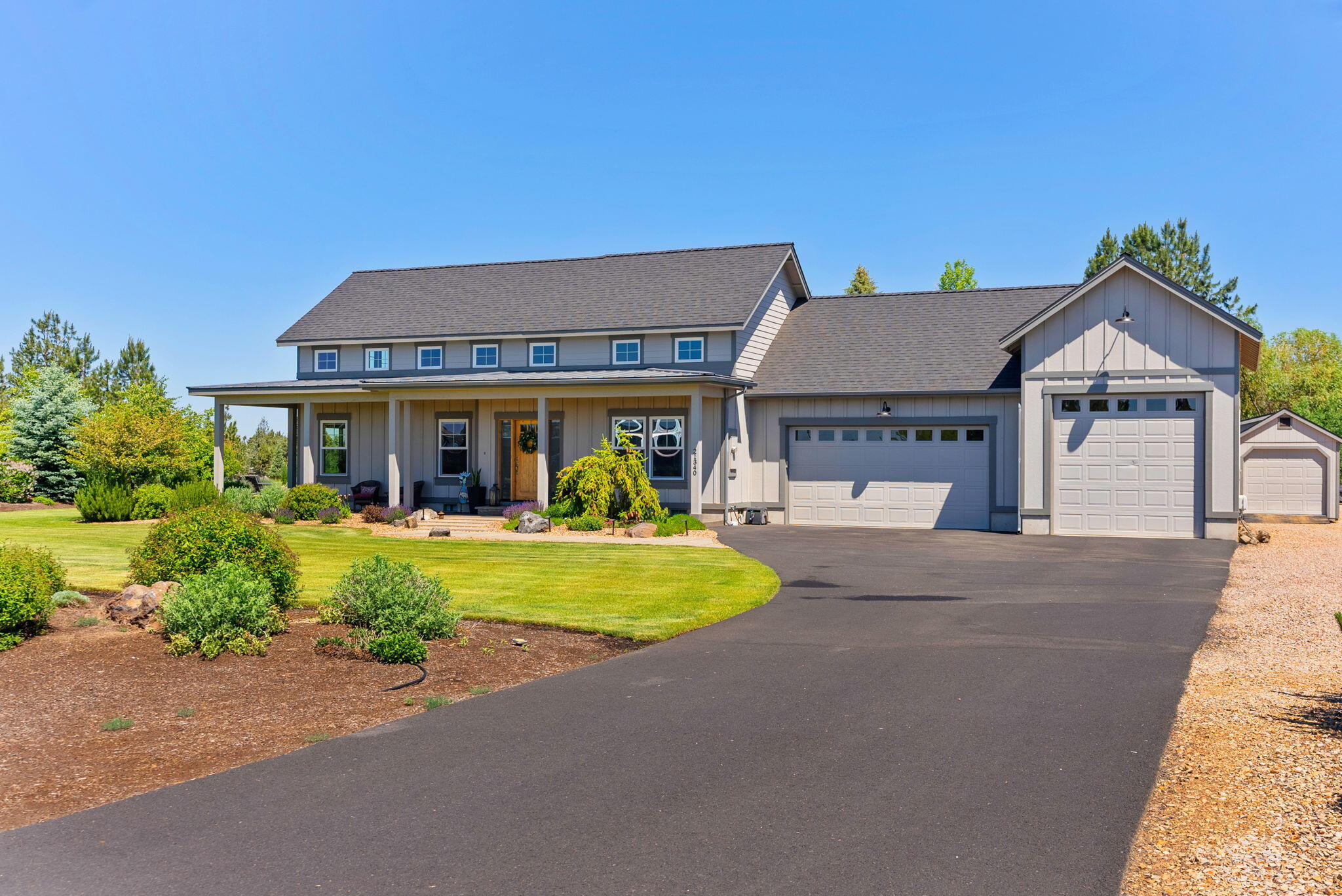 21340 View Ln where timeless style, privacy & impeccable upgrades come together to create a move-in ready sanctuary. Built in 2018, this 3-bed + office, 2.5-bath, 2,491 sqft modern farmhouse offers elevated living on 2+ acres of beautifully transformed land. Step inside to 18' ceilings, hardwood floors & seamless open-concept floor plan. The kitchen is a chef's dream w/large island, gas range, high-end stainless appliances & smart upgrades like mood lighting & motorized blinds w/timers. Magical outdoor space designed by landscape architect & enhanced w/$220K+ in upgrades, property lives like a private park. Enjoy patios for dining, fire pit under the stars & saltwater hot tub set among blooming perennials & curated trees for yr-round beauty. Beyond the home's fenced backyard is over an acre of irrigated pastureland leveled, seeded & ready for farm animals, or simply enjoying the space. 33' x 33' pond w/ cascading waterfall. 3-car garage w/10' x 10' door, 28' deep for boat or toys.