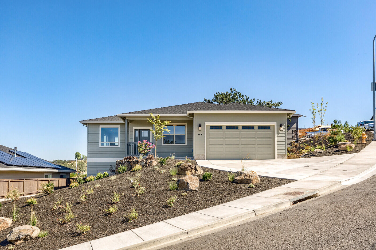 New Construction just completed. Another high quality built home by Adams Construction Group and located in E. Medford's very desirable Bella Vista Heights Subdivision. This beautiful new home is situated on a 0.24-AC view site. This contemporary style, single level 1,555 SF 3 bedroom/2.0 Bath home features: An open floor plan with a gorgeous formal entry leading into the home, 9' foot ceilings thru-out, many large windows with lots of natural light & great views. Beautiful wood & tile floors, custom kitchen cabinets & bathroom vanities w/granite counter tops, stainless steel appliances, breakfast bar, pantry, breakfast nook, coffee bar & bay window, formal dining area and a very spacious living room. The primary bedroom has French doors to a private deck area with views, tray ceiling. The en-suite bathroom has a Dbl-sink vanity, tile floors, tiled shower, large walk-in closet. Finished 2-Car garage. Beautiful low maintenance landscaping.