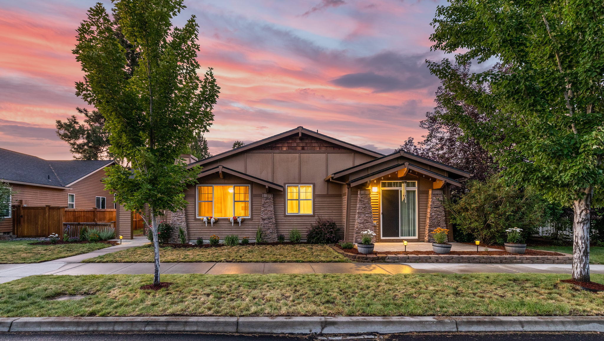 Style, beauty & function come together to create this remarkable single level home. Thoughtful floor plan lives large & open while capturing wonderful natural light from its generous picture windows. Enjoy multiple access doors to one of several outdoor living spaces that highlight a fenced yard & covered courtyard. Spacious parcel with nice tree cover provides seclusion and offers a 3-car garage & fenced small trailer/RV parking! Showcasing dramatic granite counter tops, large kitchen island, cozy slate fireplace, tall ceilings, & real hickory wood floors throughout the main living! With plenty of storage home, is both attractive & functional. Second master suite boasts a private entrance making it perfect for in-law quarters, home office, studio or guest space. Exceptional investment with optional furnishings, artwork, dishes etc. Located in a charming community with a beautiful park & nice walking paths. Minutes from trails, shopping & dining.