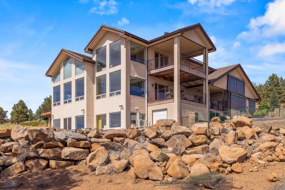 Enjoy stunning panoramic views stretching across Klamath Lake to Mt. Shasta from this beautifully crafted custom home on 5 peaceful acres. Designed for comfort & efficiency, it features solar panels, radiant floor heating, 6 mini-splits, & two propane fireplaces. Enjoy a vaulted living room, granite kitchen counters, hardwood flooring, sunroom, covered deck & stamped concrete patio positioned for spectacular sunsets. The loft office includes built-ins for two & the spacious lower level offers a family room with a Borror custom wall unit bookcase, exterior access, bedroom, bathroom, laundry area, media room, & space for wine storage. With custom artisan features, a concrete tile roof, abundant storage, EV-ready 2-car garage, & gorgeous low-maintenance landscaping, this home offers privacy & tranquility just minutes from downtown, Sky Lakes Medical Center, & Oregon Tech. A stunning property along the Pacific Flyway for viewing eagles & migratory birds. A must-see home to be appreciated.