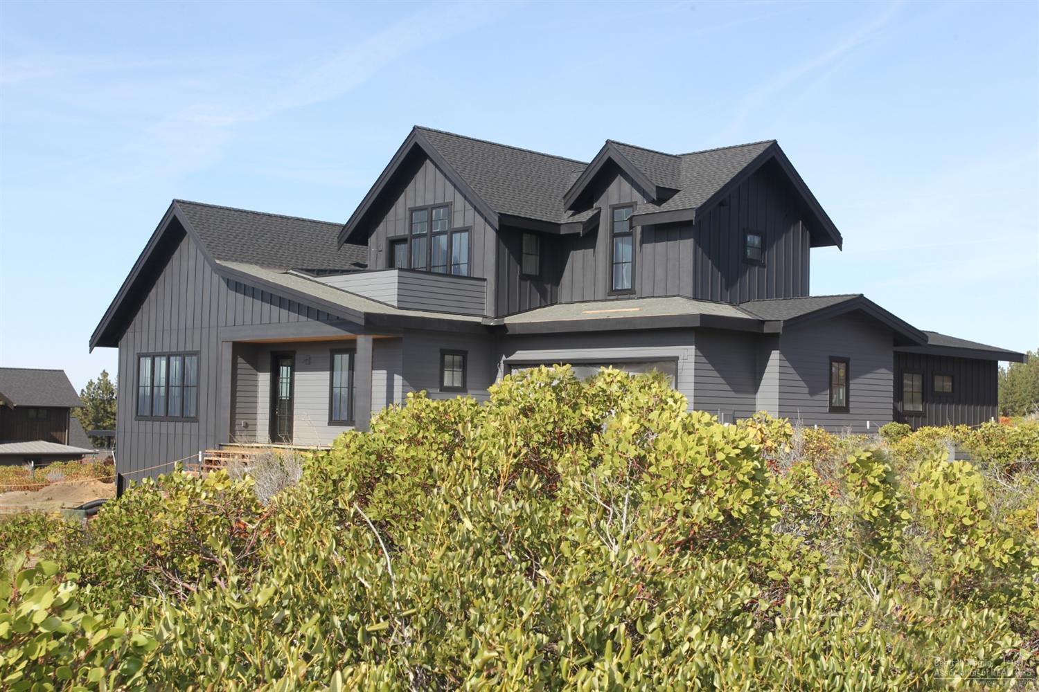 This soon to be completed custom home strikes a perfect balance between traditional farmhouse architecture & sophisticated contemporary living. Functionality and charm are at the heart of this Visionary Homes build, one of Central Oregon's leading builders. Tall windows provide natural light & optimal views of the Cascades & adjacent Alpine Park. A modern layout incorporates both light & dark elements for added visual interest. Enjoy a modern farmhouse kitchen w/ open shelving, sleek quartz counters & full appliance pkg. The dining area has large sliding glass doors that draw the eye out to a fully landscaped yard w/ gas fire pit. This ties to the Alpine Park trail system & the great outdoor living that Bend has to offer. An open layout allows for ease of entertaining & mainly ground level living including a great room, master, mud room & utility room w/ convenient dog washing station. Upstairs, a loft style bonus room w/ deck facing the mountains & 2 more beds & baths.