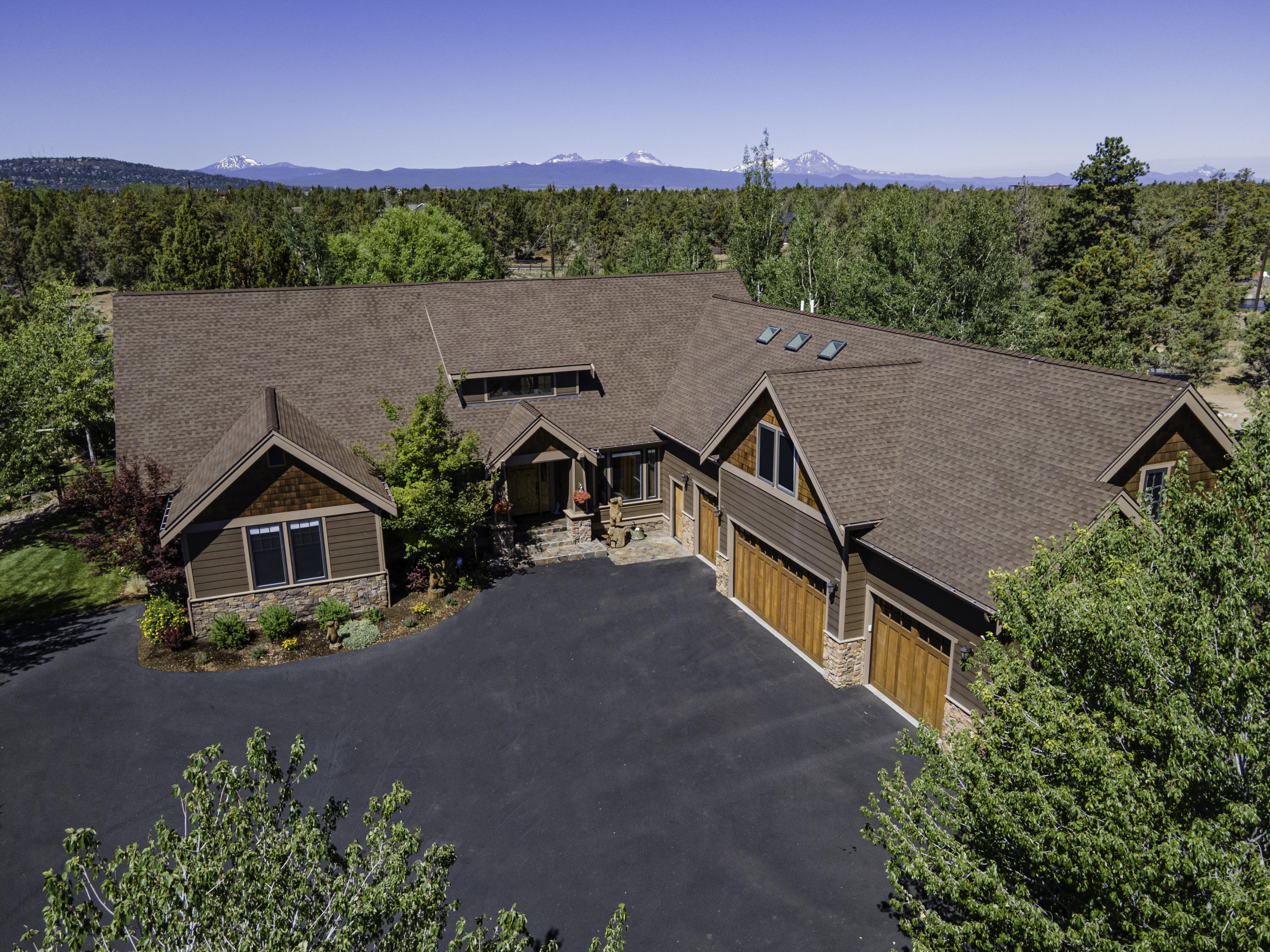 Rustic appeal on the canal, just 10 minutes from town. Many upgrades 
to the landscaping, tranquil water feature, gardens, dog run and fabulous outdoor living area! Great layout with single level living and an upstairs portion consisting of a massive bonus/game room, full bath and bedroom making a private living quarters above the 4-car garage. Spacious master suite + bathroom w/ stone + tile shower, ample storage plus a huge walk in closet.  2 secondary rooms have jack n' jill bath, closets with organizers, Pella windows, built-ins, entertaining kitchen with 3" granite slab island.  See list of other improvements.