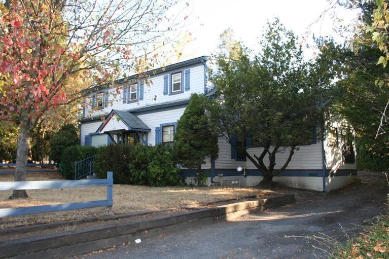 Unique Ashland Opportunity. Former group housing property on R-2 Lot with multiple uses. 8 bedrooms, 3 baths, shared communal spaces, office, large detached building for additional storage/living spaces, off-street parking and expansion possibilities. Zoning allows four dwelling units, additional lot available to expand to five units. Consider multi-family, private school, care facility, shared adult housing, boarding house, hostel, child care--the list of potential uses is extensive. A great project with long-term history in Ashland. Buyers, please check with City of Ashland for approved and conditional uses.