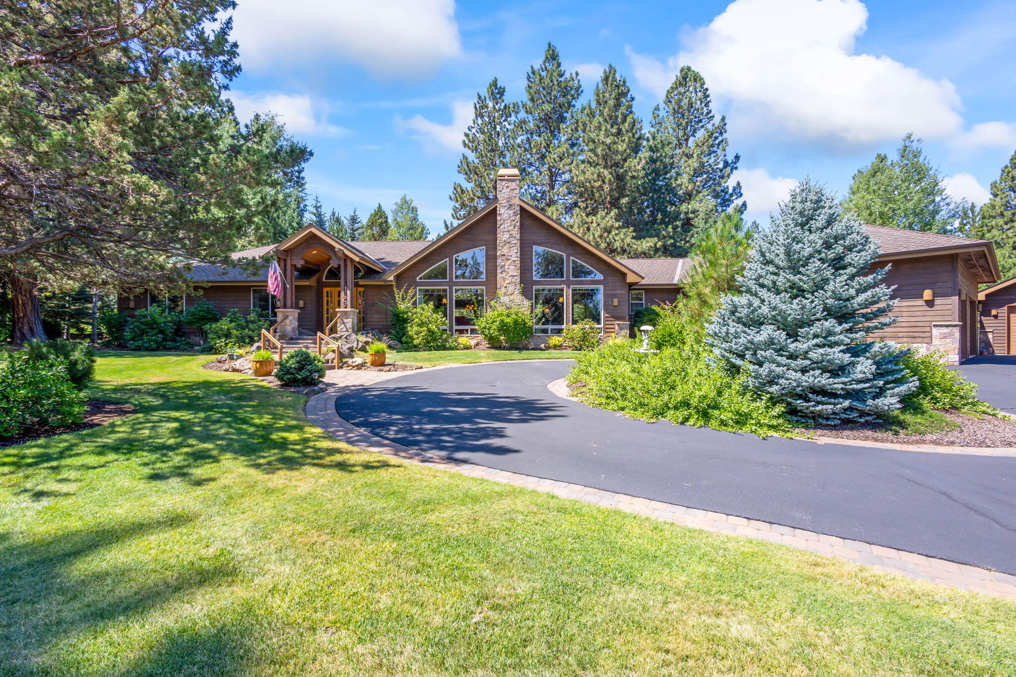 Nestled in the prestigious gated golf course community of Aspen Lakes, this exquisite 4-bedroom, 3-bathroom home is 3366 sq. ft. on a 1.19-acre lot. Built in 2003, this home has an attached 3-car garage & a det. shop, both temp-controlled w/220 power, perfect for all your projects. The circular drive adds a touch of elegance as you arrive. 
Step inside to an open floor plan with abundant wood accents & large windows, filling the home with natural light. Enjoy cozy evenings by the fireplaces in both the great room & the primary bedroom. The kitchen & living areas flow seamlessly onto an expansive deck, with a built-in Traeger grill, ideal for entertaining. 
The outdoor oasis features a water feature, mature landscaping, & an invisible dog fence. Just a short distance to The Aspen Lakes Recreation Center offering a community room, fitness center, swimming pool, spa, kiddie pool, & courts for tennis, pickleball, & basketball.
Experience the perfect blend of luxury & comfort.