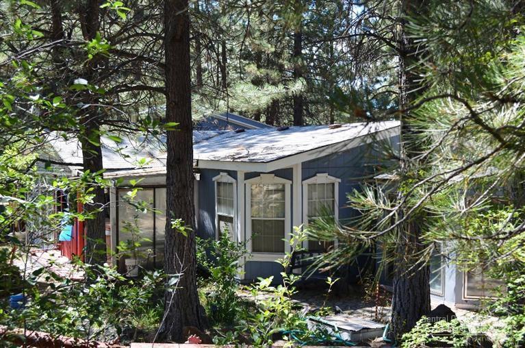 Privacy plus on .98 Acres. Nice 3 Bd 2Ba manufactured home with additional Guest House and Game room. Water Feature and multiple out buildings. Large Pantry and sun porch off the back and covered front porch. Open Bright Kitchen with lots of Storage. Bonus Craft/ Hobby Room. Multiple Fruit trees and walking path around water feature and rock outcropping.