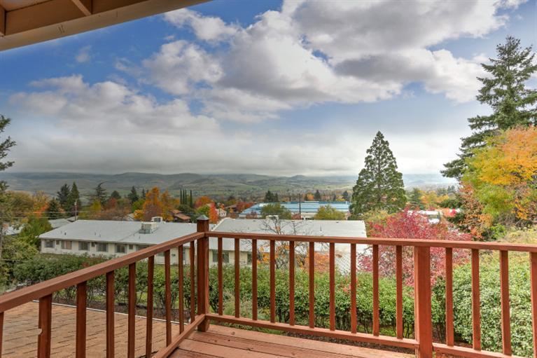 Contemporary with spectacular mountain and city views! This light-filled 2 bedroom home also has an office/den, spacious room sizes and lots of storage. The laundry/mud room connects the large double car garage to the kitchen. The kitchen opens to the dining room with views. The master bedroom suite is spacious with a walk-in closet and bathroom plus deck with views for your morning coffee or watching the alpen glow of sunsets. The outdoor living areas include a brick sitting area and decks adjoining the dining room and master bedroom. The garden features rhododendrons, large trees and other seasonal and year round color. Adjoining wall with 550 Maple Way, whose exterior was painted within the last year. The exterior was painted recently, new roof in 2007. This well constructed home is walkable to downtown. Home Warranty is included.