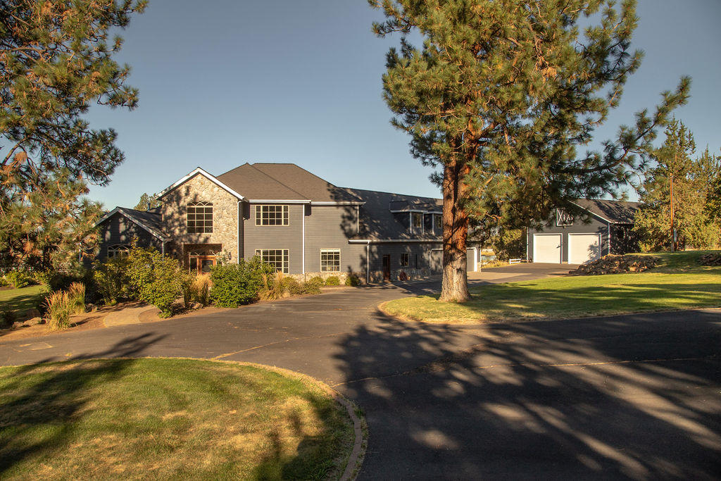If you're looking for peace & quiet here are 19.3 acres of pure bliss. The home has been updated throughout and blends quality craftsmanship with the comfort of farm house fresh updates. The home's layout is what makes it even more special. Master on the main with private stone fireplace, elegant bathroom, his & her closets all overlooking manicured pastures is a true retreat. The recently remodeled kitchen has new appliances, quartz counters, subway tile backsplash and a center island which is a focal point of the room. Up the dramatic staircase are 2 junior suites, a loft area and 2 additional bedrooms that share a spacious full bath. The entire property is gated, fenced and crossed fenced with a gorgeous 4 stall barn, tack room, round pen, office with kitchenette. All irrigation is run with underground sprinklers. There are two large RV garages, 3 car garage and more! Located in a desirable area of SE Bend, this pristine property has endless possibilities for lasting memories.