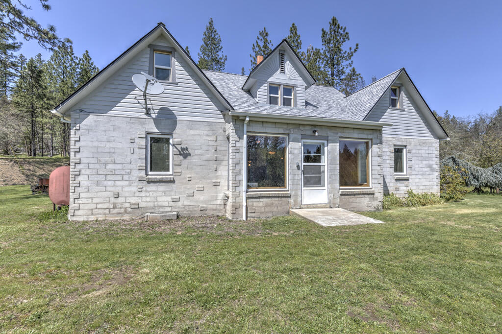 Your new home is quiet and peaceful with end of the road seclusion while close to town. 58 acres with 1500+ ft of Sucker Creek frontage! Quality built and updated traditionally styled stone 2,225 sq ft home.  Entertain family and friends with hiking, camping, swimming in your creek swimming hole and more, while never leaving home.
Expansive views of the orchard, meadow and forest.  Entry into the bright living room, open beam construction and double glass doors to the patio and the above ground pool. Kitchen has high quality cabinetry with wood sourced from the property, roll out shelves and a kitchen island with a propane cooktop.  Remodeled 400 sq ft attic with knotty pine walls and ceilings that pop with the light of the 8 dormer windows. 3 bd on the main floor with hardwood floors. Large windows in the front living room. Whole house 200 AMP generator with automatic start. Basement for storage, separate outbuilding for storage/freezer room, a shop and a tall pole barn. New 2021 Roof