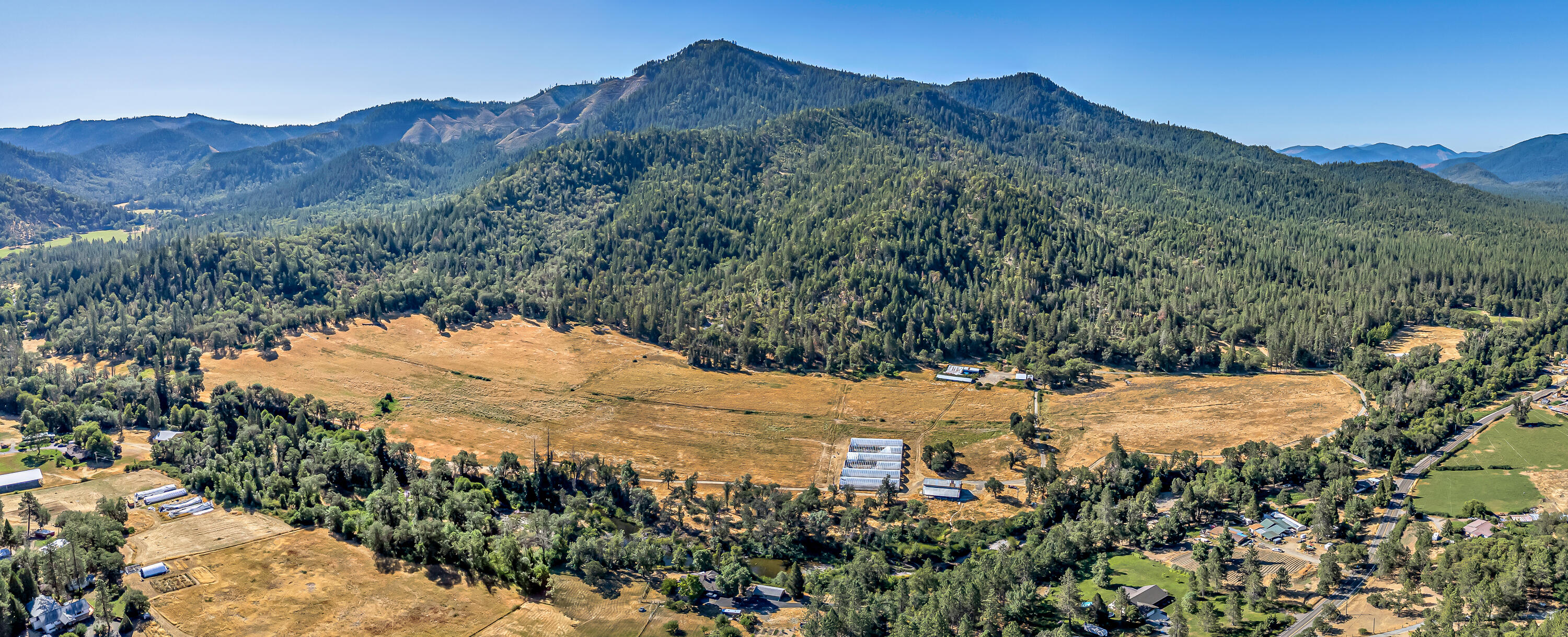 Location, location, location! If you're looking for pasture in the heart of Southern Oregon, this is the one for you! This one-of-a-kind property features 579.54 acres (57+ acres are irrigated and irrigation rights date back to 1881), 4 tax lots (Zonings are EFU & WR), marketable timber, multiple outbuildings, 6 industrial greenhouses, 1200 amps of power, large 3960 sq ft barn, homesite approval, gated access, and nearly 3000 ft of E Evans Creek frontage! Property backs up to BLM and offers a very pleasant setting that feels private yet within 15-20 mins from downtown Rogue River. Truly a perfect opportunity for anyone that wants to build their dream home on a generational ranch and/or grow marijuana. Owner carry terms are considered too. This one won't last long on the market, so contact your agent today for a personal tour, before it's too late!