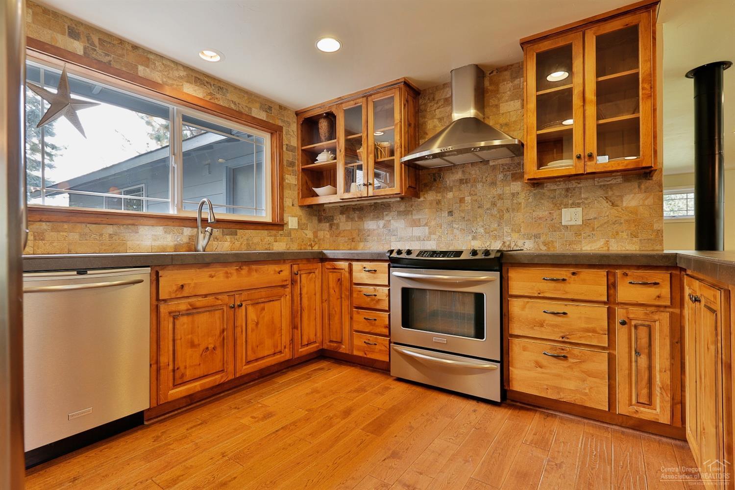 Beautifully remodeled single level home w/contemporary design. Inviting sunken living room to curl up in front of gas fireplace or window seat & enjoy your park setting. Ideal chef kitchen: plenty of storage, wrap around counter w/bar seating, S.S. appliances. Family & dining room shine w/grid style French doors & windows. Open floor concept w/efficient free standing gas stove. Four bedrooms could easily be altered to 5. Mature landscaping, RV parking, cul de sac location & 1/3 acre make this home a winner!