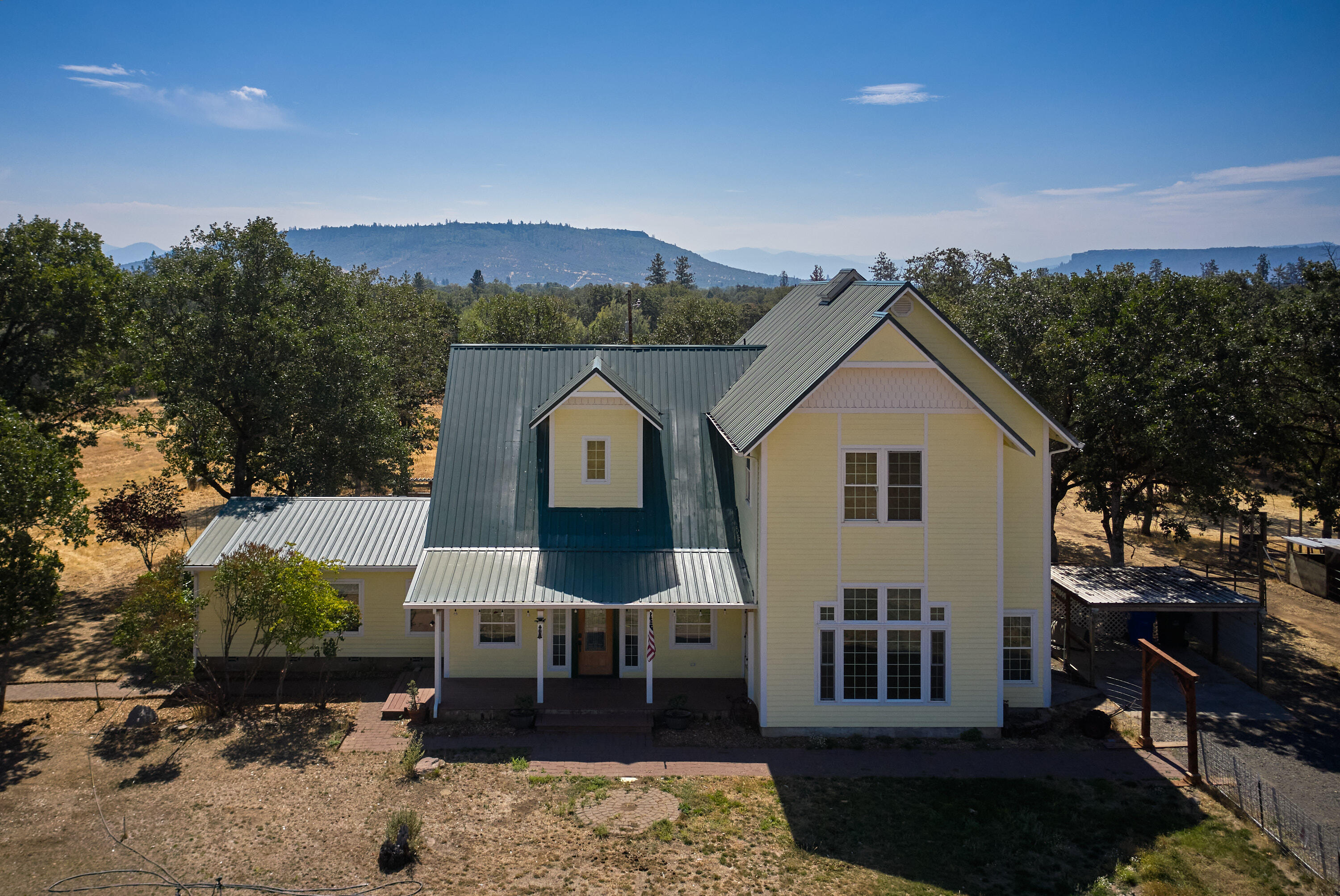 Discover a one-of-a-kind retreat! This beautifully remodeled and expanded manufactured home sits on over 9 acres of EFU-zoned land, offering 3,328 sq. ft. of luxurious living space. With 4 bedrooms, including two master suites (one upstairs and one downstairs), and 3 full bathrooms, this property seamlessly blends modern upgrades with rural charm, complemented by two, 2-car garages. Perfect for those seeking space, privacy, and versatility, this home is a must-see gem!
