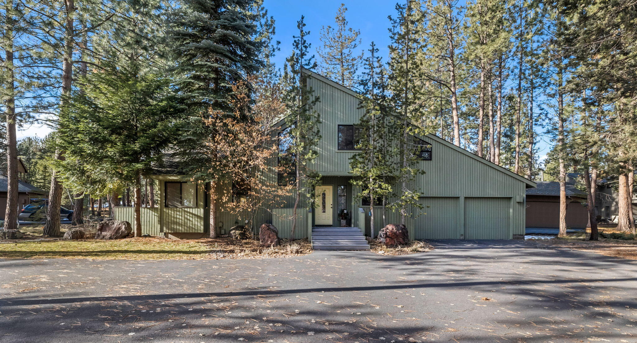 Discover NW living at its finest in the desirable gated neighborhood of Sunrise Village on Bend's West side, close to Mt Bachelor & Cascade trails.  This warm, contemporary home sits on a large .59-acre wooded lot w/landscaping.  The great room welcomes you with a vaulted cedar ceiling, a free-standing fireplace for chilly nights, and new wood look laminate floor that extends into the cozy den and office.  Outside, an expansive Trex deck reaches the length of the house, creating an inviting summer living space.  The spacious kitchen features solid surface counters, newer appliances, and a large pantry.  Upstairs 2 bedrooms share a full bath with tons of closet space and a convenient laundry room.  The primary suite offers dual vanities, an updated tile shower, and a new  closet organizer.  The 4th bedroom on the main level provides a full bath and privacy for guests.  SRV owners enjoy direct river access, walking/biking trails, pool, hot tub, tennis courts & more.