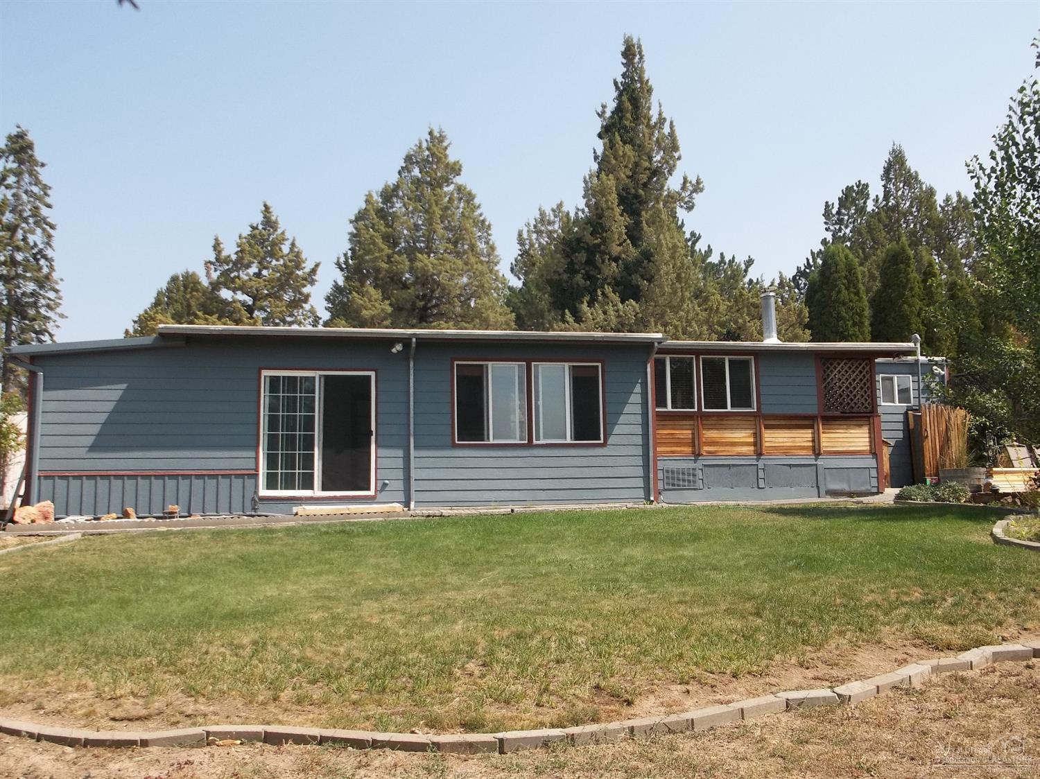 Super cute remodeled manufactured home on almost 1/2 acre, fenced backyard and lots of trees for privacy. Fabulous Mt. view from kitchen window. Community water only $240 a year. New septic tank in 2012. Has car port, shop, two storage buildings. Property backs up to large private property. So very private.