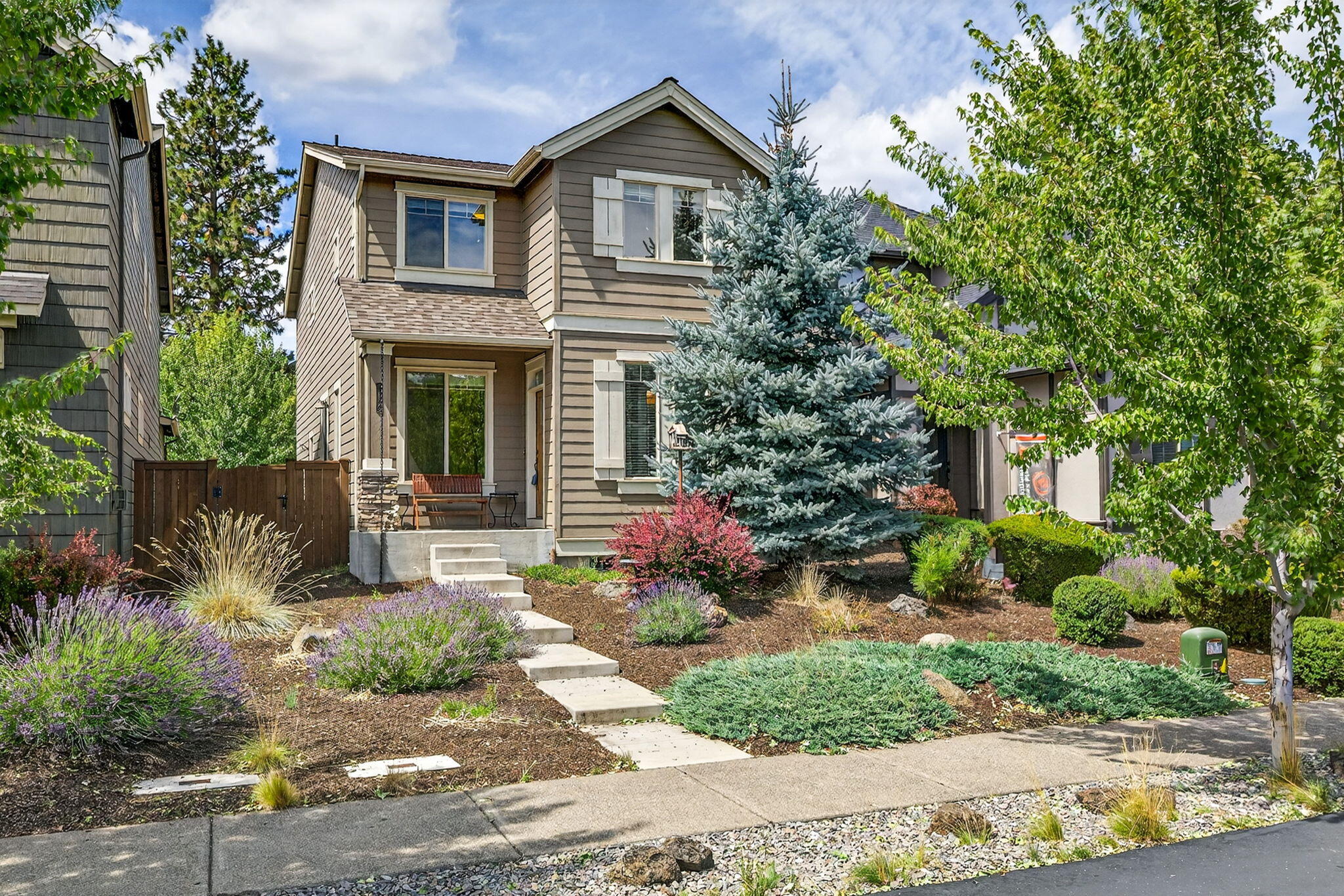 Ideally situated in the sought-after Bridges community, this meticulously maintained two-story home offers 3 bedrooms, 2.5 baths, and a thoughtfully designed open floor plan. The inviting great room features a striking stacked-rock gas fireplace, while the upgraded kitchen boasts stainless steel appliances, quartz countertops, backsplash, breakfast bar, and warm alder cabinetry. Upstairs, a versatile loft provides a perfect space for a playroom, home office, or cozy second lounge. The private side yard is ideal for outdoor dining and entertaining year-round. As a resident of The Bridges, you'll enjoy resort-style amenities including a pool, hot tub, playground, BBQ area, fitness center, indoor basketball/volleyball court, game room, and a clubhouse with a full kitchen, bar, and lounge for hosting events. Located just 10 minutes from downtown Bend and mere steps from the new 37-acre Alpenglow Park.