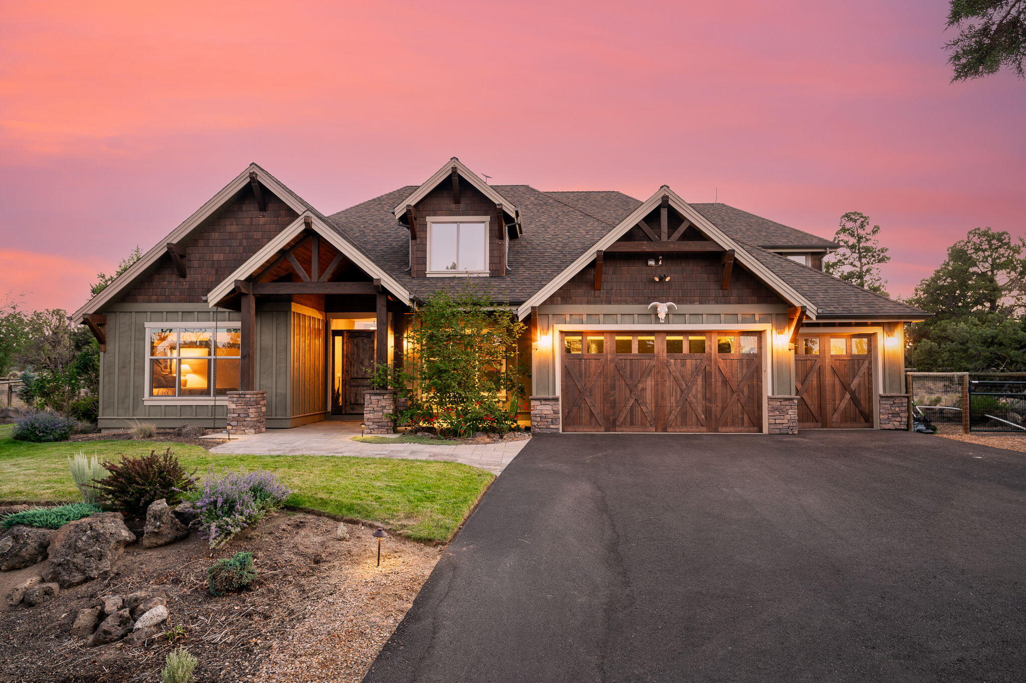 Experience the serenity of this remarkable 4+ bedroom home set on a picturesque 11.8 acre lot just 10 minutes from town. A private paved driveway welcomes you to this breathtaking residence bordered by BLM land. Step inside the vaulted great room with stone fireplace + custom knotty alder cabinetry. The main floor hosts most of the living space, including luxurious primary suite featuring a wall of knotty alder cabinetry, a spa-like bathroom with a soaking tub and steam shower + a spacious walk-in closet. French doors open from the primary suite to a backyard paradise, fully fenced yard; natural swimming pond, waterfall, sandy beach + immaculate landscaping.  The 2nd floor has a bonus room (5th bed) + large family room w/ 2 queen murphy beds. Enjoy outdoor living with large covered patio, fire pit, dual sound systems + a dedicated play area. There's a fenced area for animals, shed + coop, powered utility shed + ample space to further develop. Expand the vision + make your dream home!