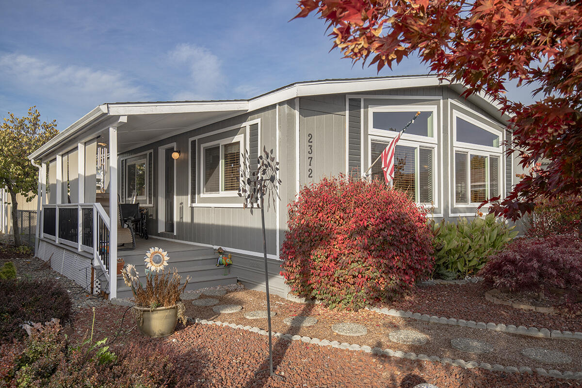 Wonderful Manufactured Home located in one of the Most Desirable Parks in Grants Pass! The Superbly-Kept Home offers a Light Open Floor Plan, Large Living Room, Attractive Useable Kitchen, & Nice Dining Area. The Master Suite offers an Attractive Bath & Walk-in Closet! You will be pleased by the many Fantastic Recent Upgrades & Updates here. Your concerns about Major Expenditures will be mitigated by the Newer Flooring, Paint, Front Covered Deck, Windows, Counter Tops & 'Roof-Max' Roof Coating completed in 2024! Outdoor Living can be readily enjoyed from the Large Covered Front Deck. The Paved Drive, Carport & Shed offer plenty of Parking & Storage. The Desirability of this Park is Magnified by the Amazing Community of People, &  Unexpectedly-Low Affordable Space Rents. This is Simple Easy Living just on the Edge of Town, but in a Fantastic Community, moments away from Parks & the Rogue River!