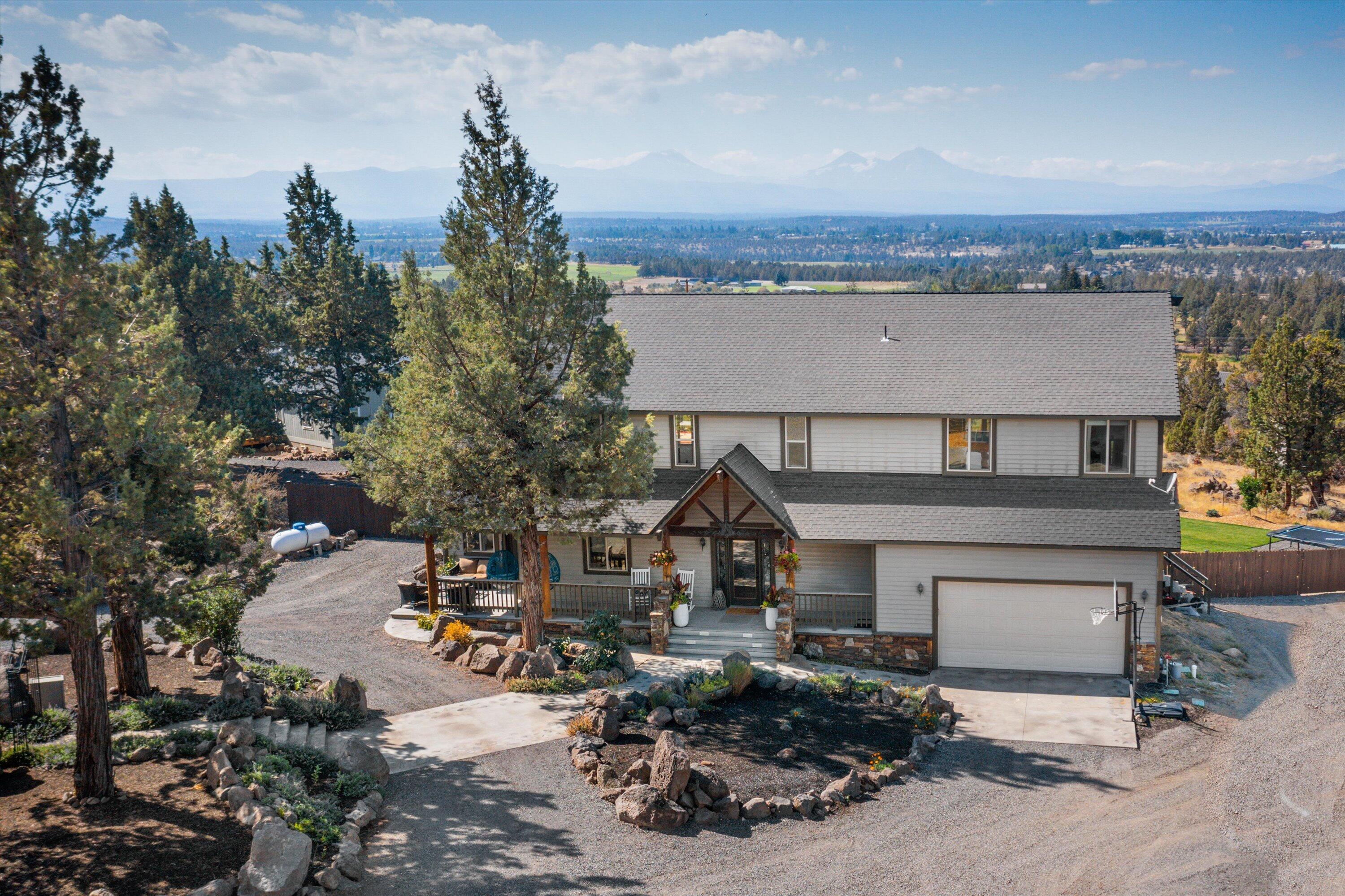 Newly Remodeled. Beautiful Cascade Mountain Views from home on 2.43 acres located Bend and Redmond. Traditional Style home is 3025 sq ft, 3 bedrooms, 4 bathrooms, open floor plan, living room with fireplace, dining area, covered porch and deck access. Large Master suite with fireplace is upstairs with deck. Attached two car garage with workshop space and storage shop area.