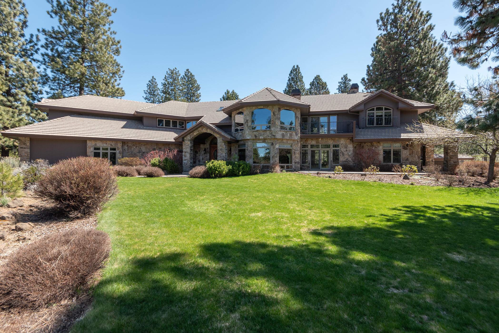 Experience luxury living at its finest in this exquisite home in Sunset View Estates. Nestled on a double lot offering unparalleled elegance and sophistication. Enjoy the perfect blend of comfort and style with breathtaking mountain, pond and golf course views, and a parklike yard. Impeccable craftsmanship is evident throughout; from the grand foyer to the gourmet kitchen featuring top-of-the-line appliances to 5 fireplaces. Entertain effortlessly in the welcoming formal and informal spaces. Take in stunning sunsets and natural vistas from expansive patios. Experience the epitome of today's luxury living, with every detail carefully curated for discerning tastes. Featuring a primary suite, 3 guest suites, executive office, theater, game room, elevator, workout room with indoor sauna and hot tub, a 4-car garage plus golf cart bay.  There is even a dog shower and run for your furry friends. Don't miss the opportunity to call this home yours. Live a private Bend lifestyle in luxury