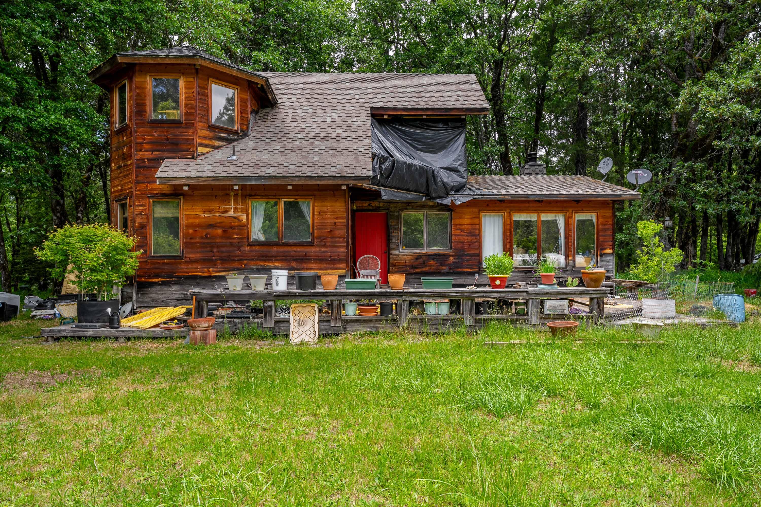 Welcome to nature's retreat! At the heart of this property sits a 1,479 Sq Ft timber framed home, exuding rustic elegance with T&G pine ceilings & exposed wood beams! Wood stove for heat & ambiance. Detached living space with potential for family, guests, or rental income. Attached to the living space is additional storage. The 3,500+ Sq Ft AG building/shop is perfect for housing equipment, vehicles, or hobbies! Property includes 11.8 acres of RR5 zoned land, offering potential for another home. Over 5 acres of meadows provide plenty of room to farm, garden, and more. A stately redwood tree adds a majestic touch to the landscape, while the surrounded wooded areas offer peace & privacy from neighbors. Enjoy the tranquility of Indian Creek, while also using irrigation rights. Previous farming did not use pesticides. Domestic water comes from a spring/cistern. Pond is great for irrigation & wildlife, including fish & birds. Near BLM! Owner carry with 50% down. Open to creative offers!