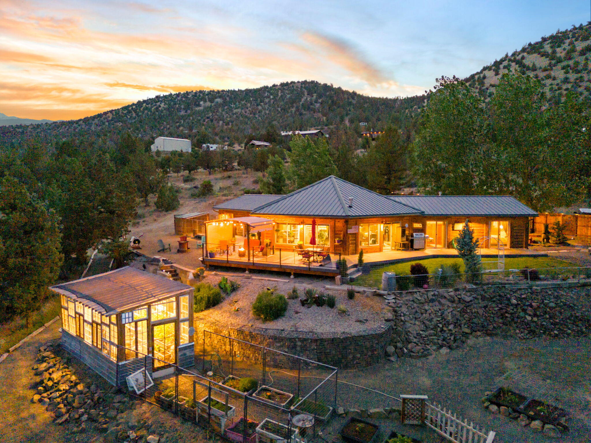 Perched above Prineville Reservoir, this stunning custom log home offers panoramic lake views and luxurious updates throughout. Fully remodeled with LVP flooring, quartz countertops, designer lighting, custom cabinetry, and a Thermador propane range. The chef's kitchen opens to a spacious living area with walls of windows to take in the view. The spa-like primary suite features tranquil lake views, a custom walk-in closet, tile shower, and double vanity. A split floor plan offers privacy with two guest rooms and a beautifully updated bath with clawfoot tub, tile shower, and quartz vanity. Step outside to a brand-new Trex deck with railing, a generous fire pit area, fenced garden, and greenhouse. The property also includes a detached 3-car garage, 20x24 shop, and 50-amp RV hookups. Sold fully furnished and move-in ready, perfect as a full-time residence, vacation getaway, or short-term rental opportunity. Don't miss this rare retreat with unmatched views!