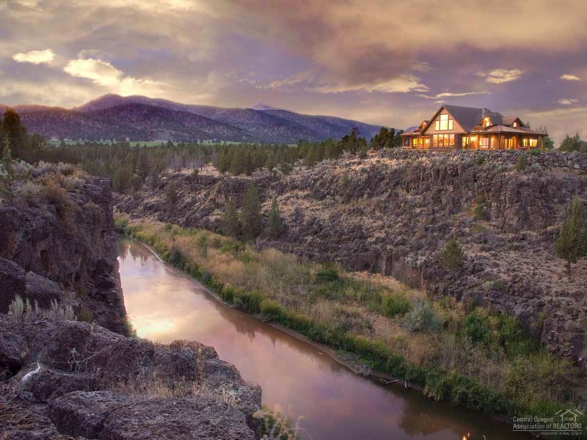 Once in a lifetime, a property comes along that exceeds every expectation. Miles of Crooked River and Cascade Mountain views, in addition to a dream house of high end quality. Main level master & private bedroom suites-all with amazing views. Two more dwellings, within walking distance of the main home, offer compound options or ranch help living quarters. The state of the art barn, roping arena and outbuildings will rival any high performance ranch. If a ranch is in your dreams, then this is your new home.