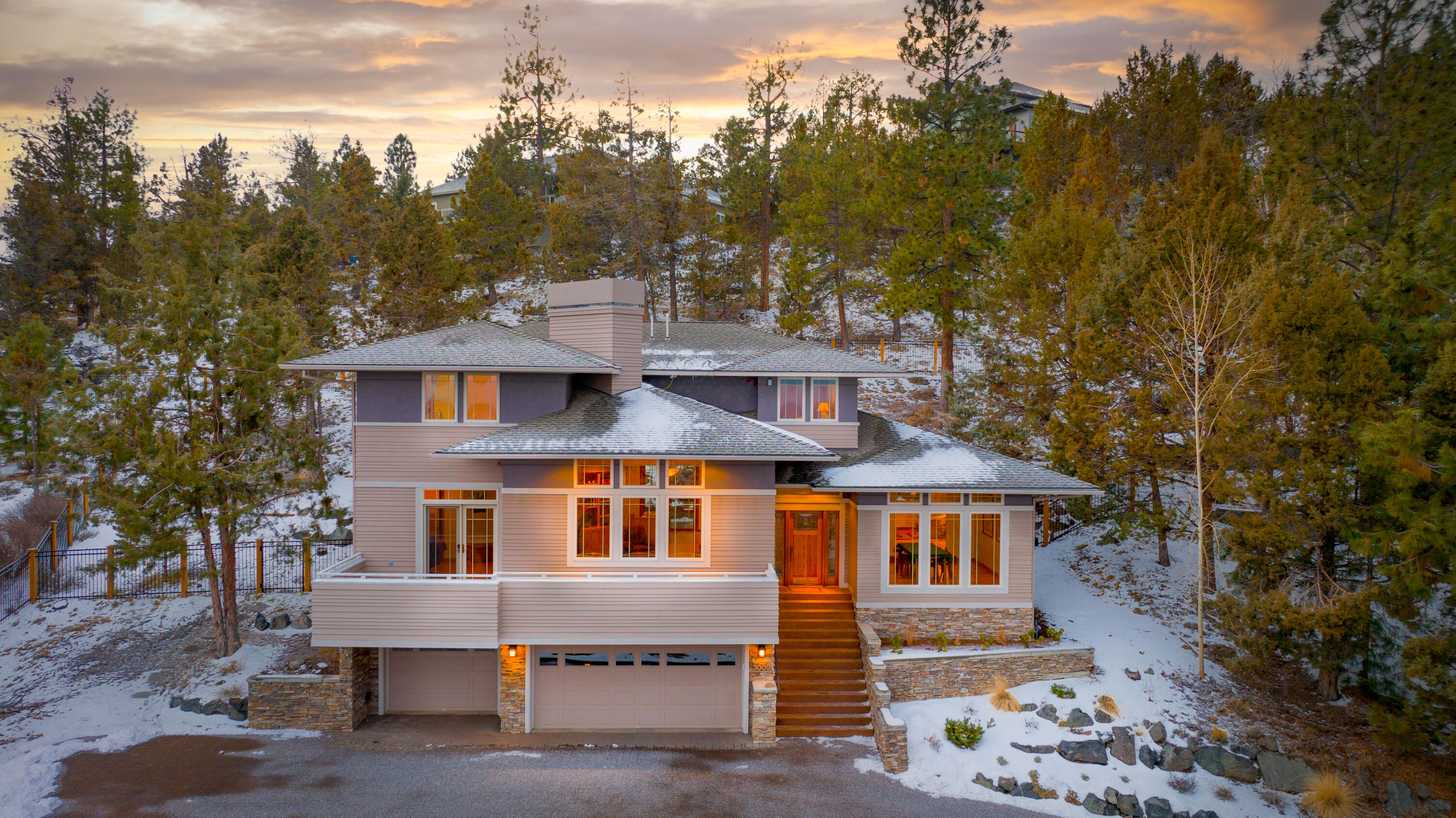 Perched on a sunny lot in Bend's charming Awbrey Village neighborhood, this home is striking yet versatile. Here, buyers will enjoy views of Smith Rock, Powell Butte, and the Ochoco Mountains from nearly every room of the well-built, transitional-style home. Sweeping and spacious great and dining rooms set the perfect background for quiet relaxation or joyful entertaining. Enjoy views of the cascading rock garden and patio from the kitchen, and experience the warmth of hardwood floors and cabinetry. Downstairs, enjoy a cool retreat with cork flooring which is perfect for fitness or business. Upstairs, the primary suite has excellent views and illustrious morning sun as well as two additional bedrooms - one ensuite - with room for all.