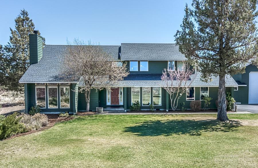 Custom built home on two acres adjacent to common land & BLM trails,park like setting with views of the cascades.Fully landscaped fenced back yard,gazebo and large deck.Main house boasts 3 beds,2.5 baths,hickory floors, chef kitchen, granite, custom cabinets, family room,formal living, floor to ceiling wood fireplace, formal dining.Master bedroom suite, his and hers closets, custom cabinets, walk in shower & jetted tub. RV garage/guest house,1 bed, loft,1bath, kitchenette,pellet stove.