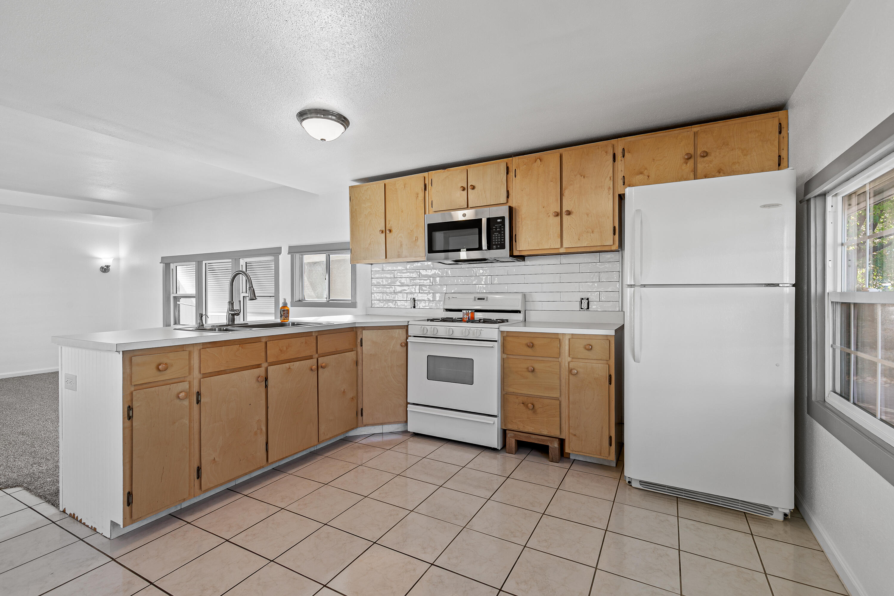 This move-in ready home is conveniently located in a senior park near shopping, restaurants, and public transit. This home offers both comfort and accessibility. Inside you'll find fresh interior paint, new carpet, updated fixtures, and a fresh tile backsplash in the kitchen. Enjoy low-maintenance landscaping, a covered patio perfect for relaxing, and room for small garden beds. The attached carport provides parking for two vehicles plus a storage shed for your tools and hobbies. With new metal skirting, central heating and air, laundry hookups and a light and bright atmosphere, this home is a rare find!  Space rent is $800 per month, 2 pet limit under 25 lbs.