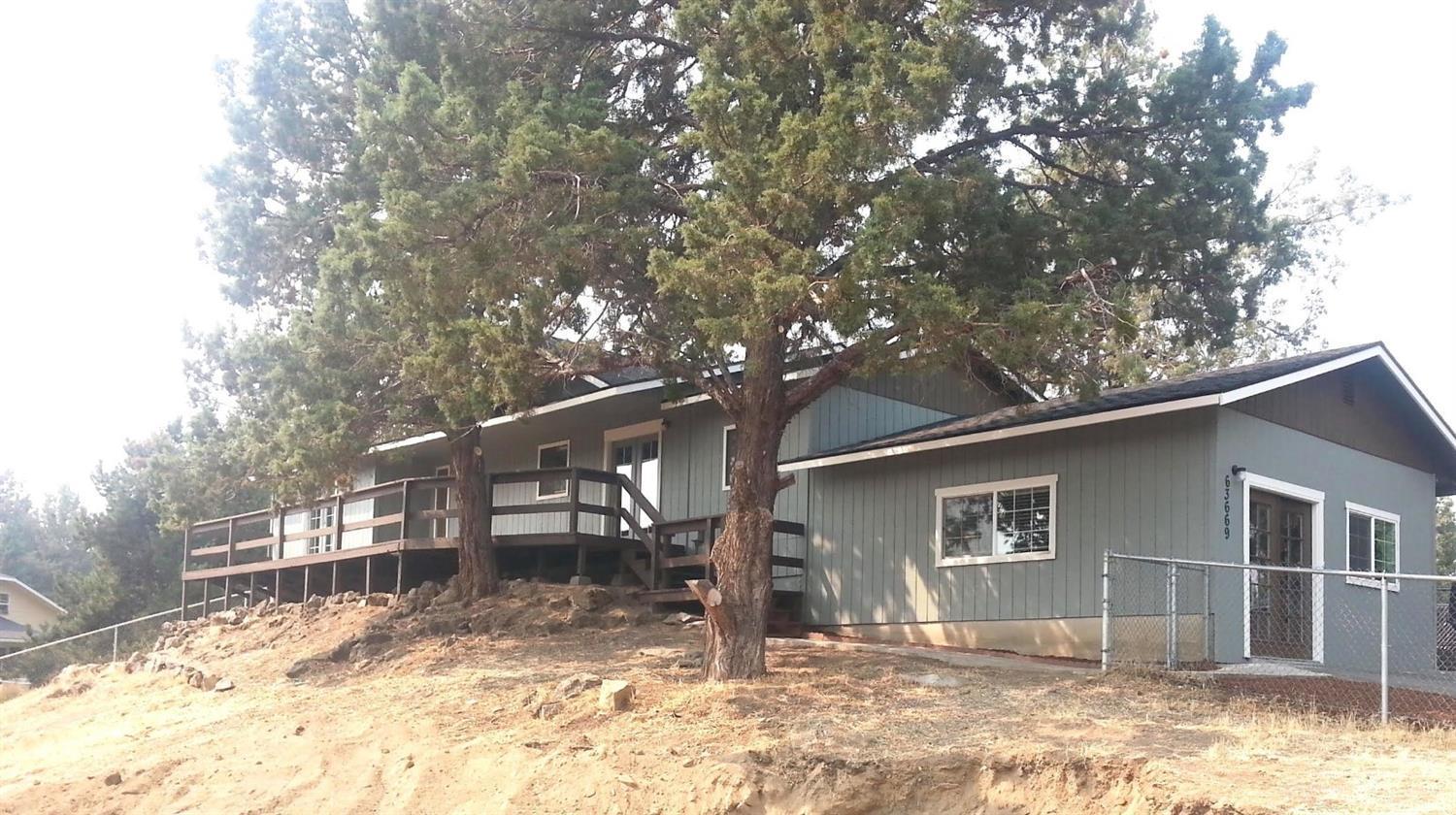 Newly remodeled home! New roof, new septic tank, flooring, paint inside & out, decking, and various other items. Home looks and shows great. Large .34 fenced lot with abundance of room. Nice living area with pellet stove. New laminate flooring opens to dining area with room for all. Square footage includes 420 sq.ft. garage conversion. Lots of trees and room for your touch on the landscaping.