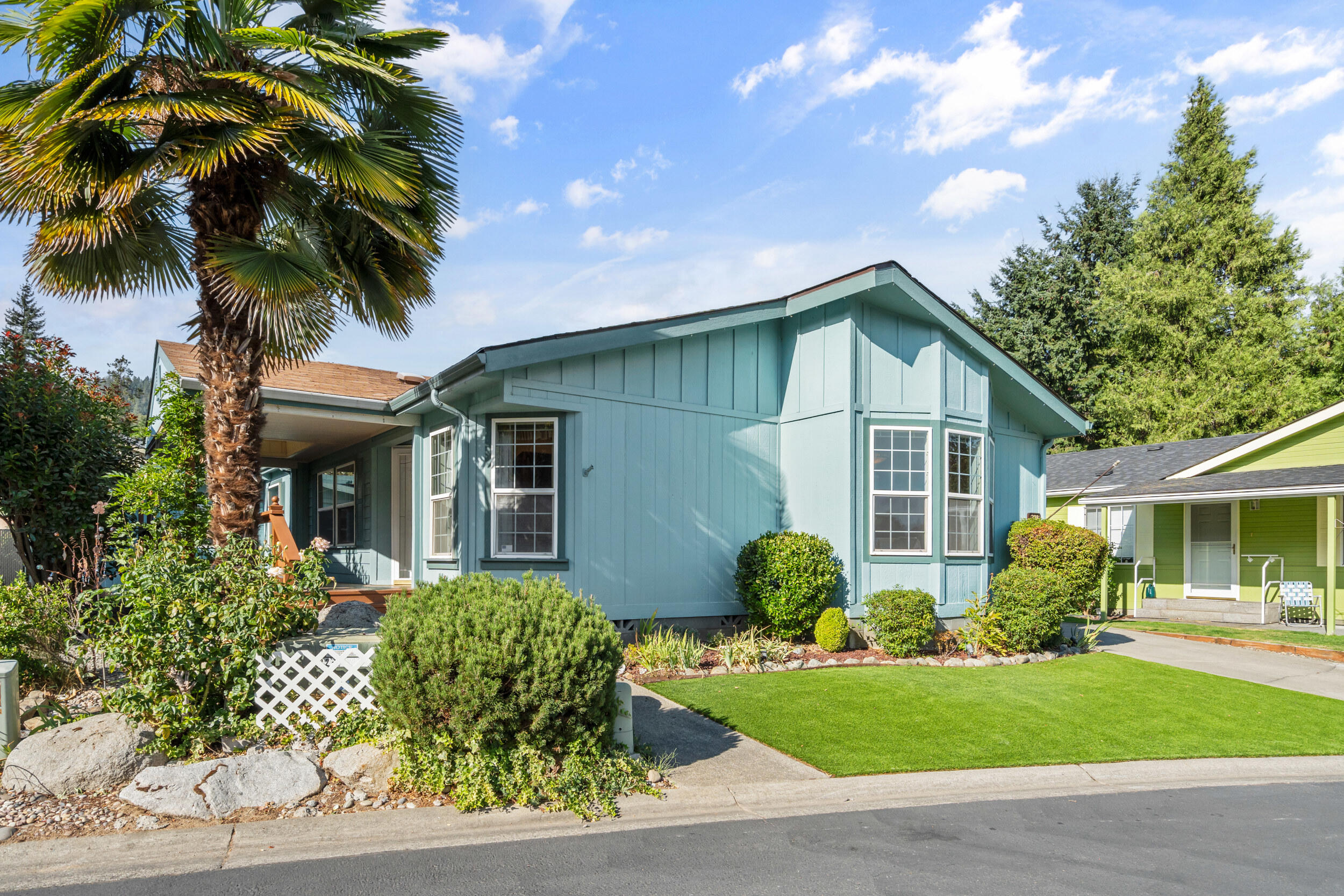 Welcome to Highland Heights, one of Southern Oregon's desired 55+ communities! This spacious 3-bedroom, 2-bath home offers 1,518 sq ft of comfort with a formal dining room, arched entry, and a well-designed kitchen with island and ample counter space. The primary suite is a true retreat with double sinks, soaking tub, separate shower, and a versatile bonus room. Updates include fresh paint and laminate flooring. Relax on the covered front deck, enjoy low-maintenance landscaping with turf yard, plus a tandem carport and large storage shed. Built in 1999 and well cared for, this home is move-in ready. Space rent $850/month, covering water, sewer, and trash. The park enjoys well water. The residents love the clubhouse where residents enjoy several weekly community activities. Pet-friendly with approval.