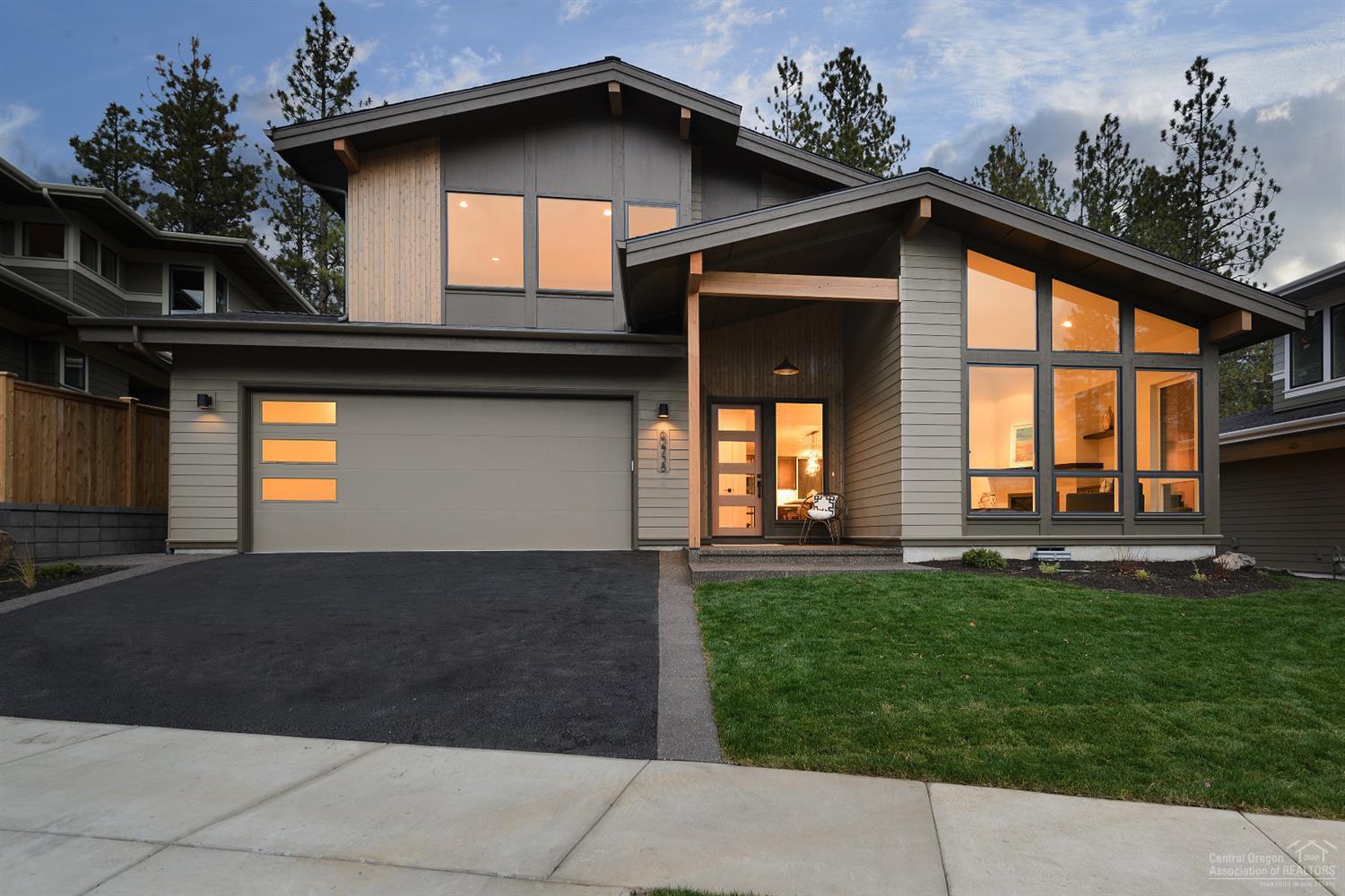 Mid-Century Modern style home featuring vaulted ceilings, covered dining terrace & contemporary finishes. Open floor plan with abundant natural light, gas fireplace & custom built-ins. Hardwood floors throughout main living area. Kitchen with slab quartz counters, large island, commercial style range & hood. Master suite on main floor. Master bath with walk-in tile shower & floor. Large bonus room adjacent to 2 bedrooms & full bath upstairs. Laundry with built-ins & mud room. Oversize 2-car garage.