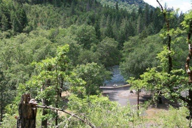 Great 5-acre building site in the trees across from Rogue Elk Park and the Rogue River. Well with pump. Power and telephone available. Approximately 300 feet to the Rogue River and boat ramp. 7.5 miles to Lost Creek Lake Marina at Stewart State Park. 5 miles to Shady Cove. 16 miles to Eagle Point and Wal-Mart Super store. Come experience this special property with views of the Rogue River.