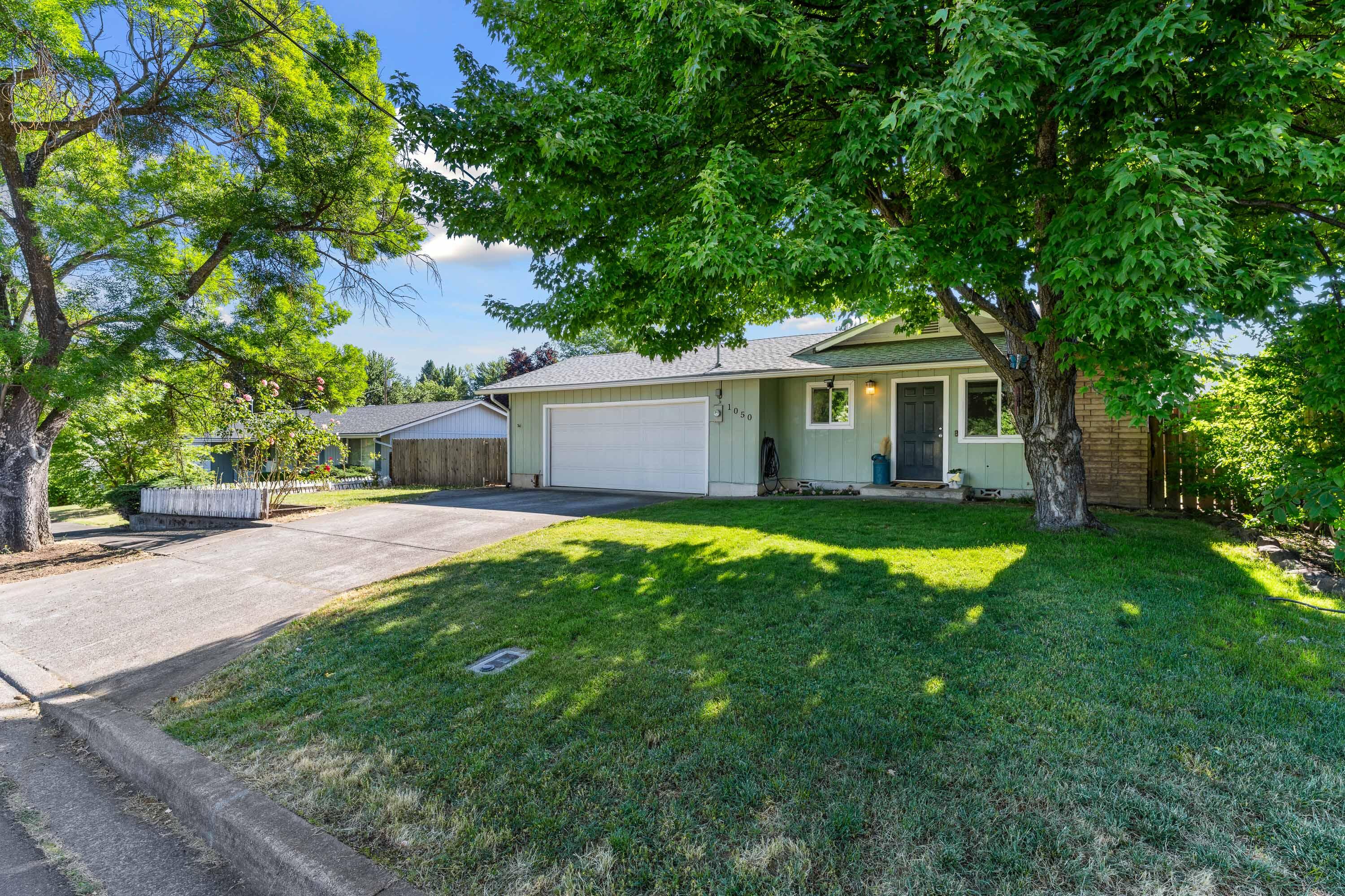 Beautiful East Medford Gem! This 3 Bedroom 2 Bathroom home has over 1,230 sqft and sits on a .18 acre lot. Newer LVP Flooring throughout the entire home with Carpet in the Bedrooms and Tile in the Bathrooms. Gorgeous corner Fireplace insert with floor to ceiling brick create a one of a kind accent piece. The oversized Backyard is fully fenced with a small patio, Slate Stone Fire Pit and storage shed that has power. New Roof installed in 2020 along with a Brand New Water Heater, Furnace and HVAC system installed in 2023. All while being centrally located 1 mile from Restaurants, Shopping, Parks and Entertainment. Call to schedule your private tour!!